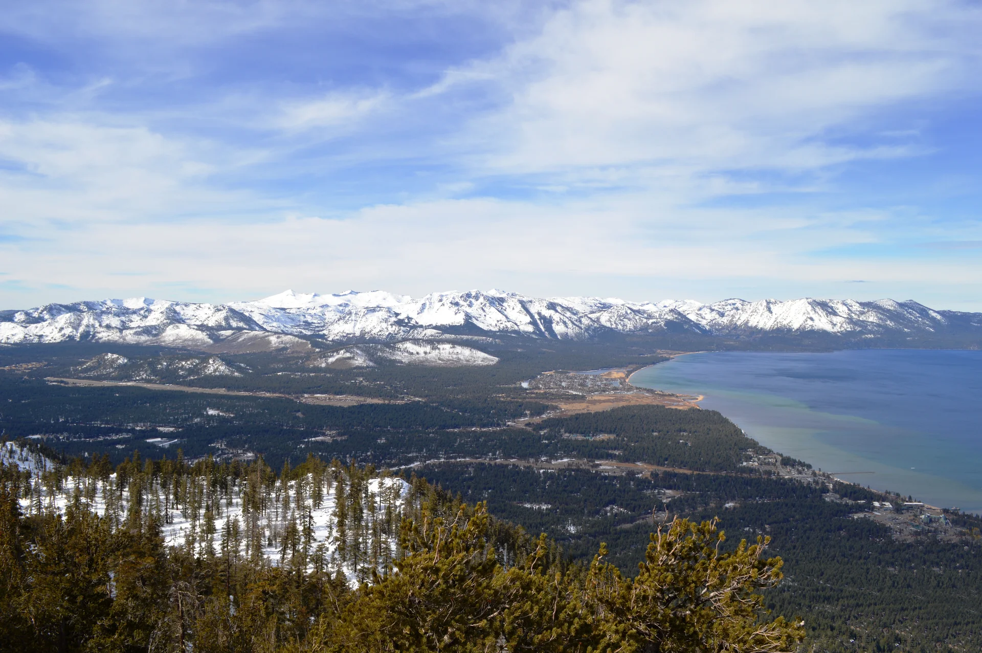 Snow-covered Sierra Nevada mountains and Lake Tahoe viewed from Heavenly