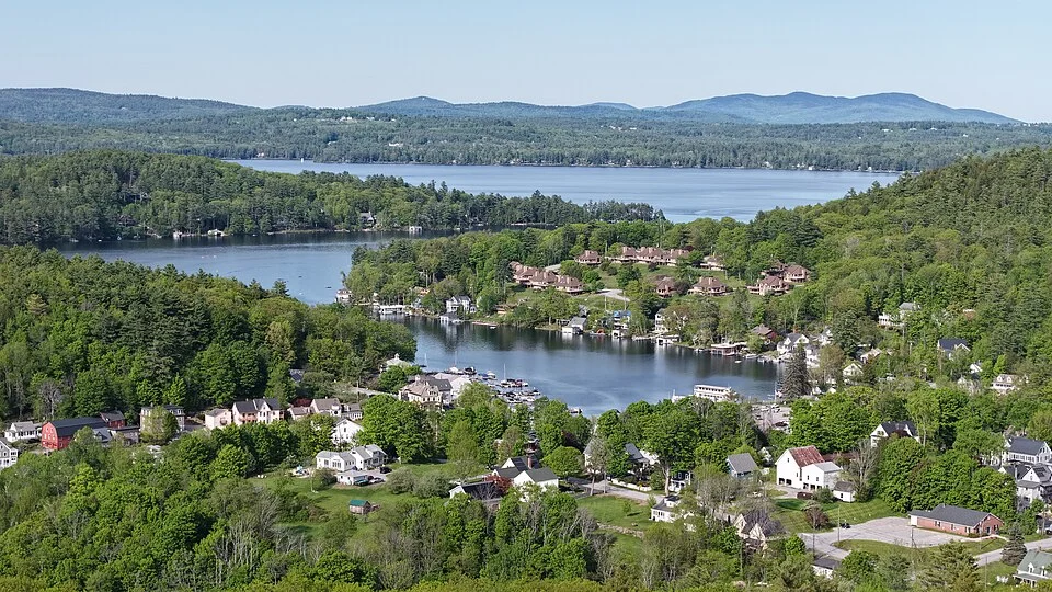 Lake Sunapee with wooded shore and lakeside homes