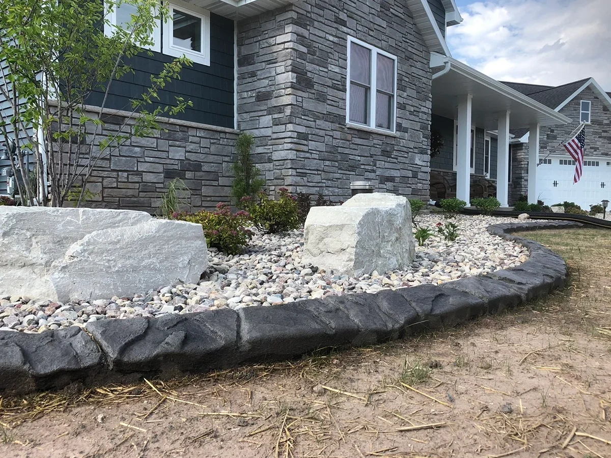 Decorative curbing around a residential rock garden