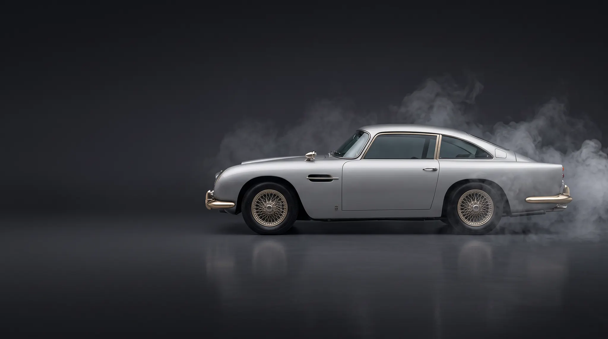 Silver classic Aston Martin shown in profile