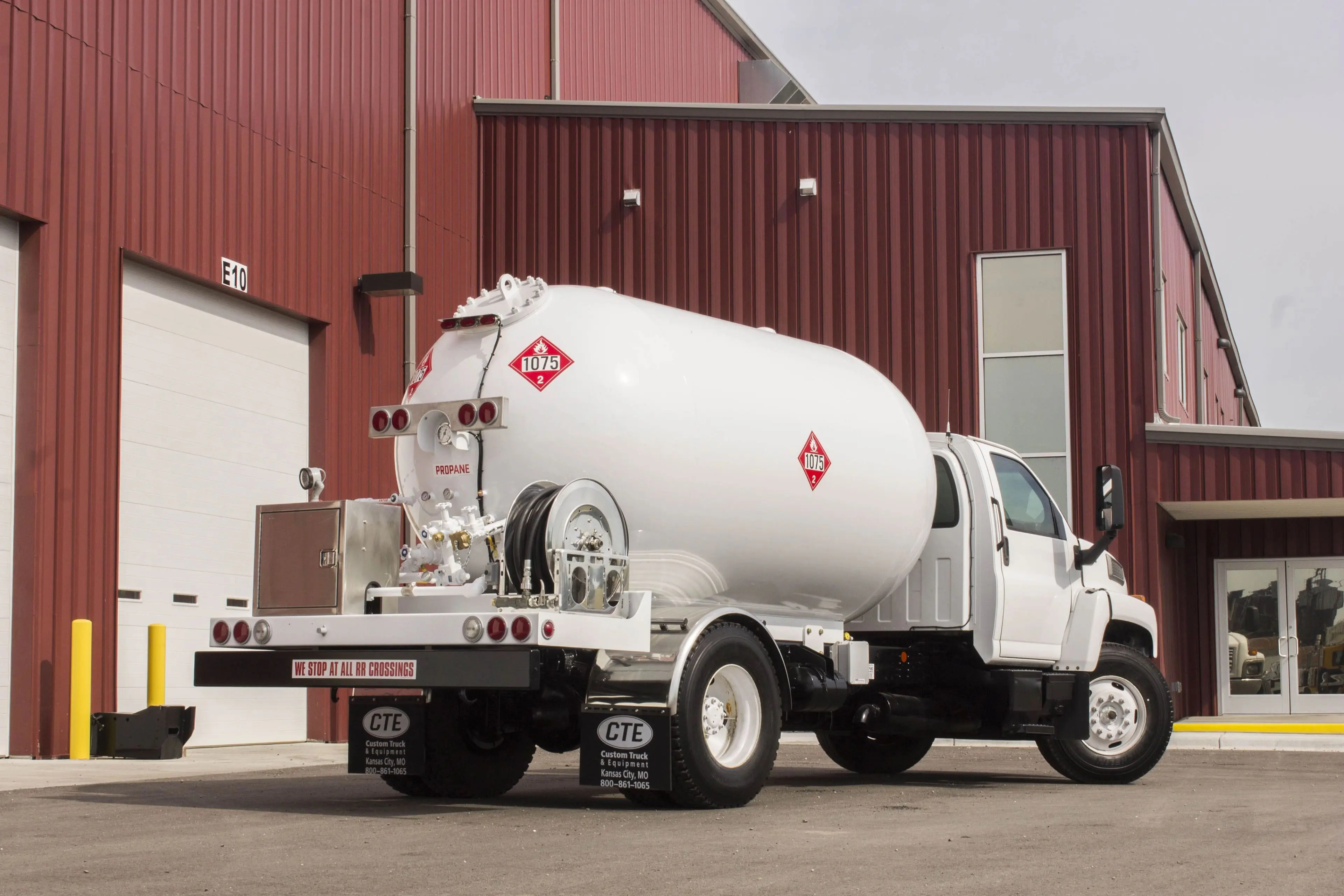 White propane delivery truck parked outside a service facility