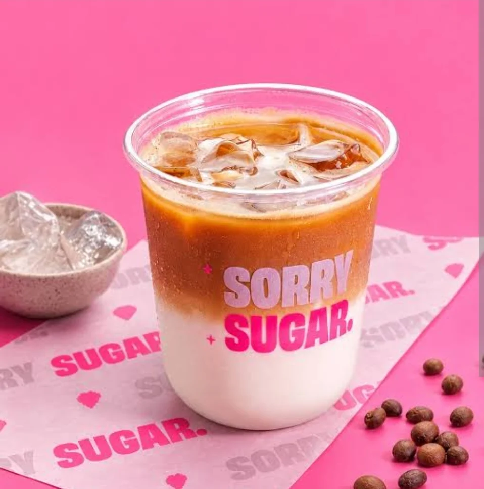 Sorry Sugar iced coffee campaign on a vivid pink set