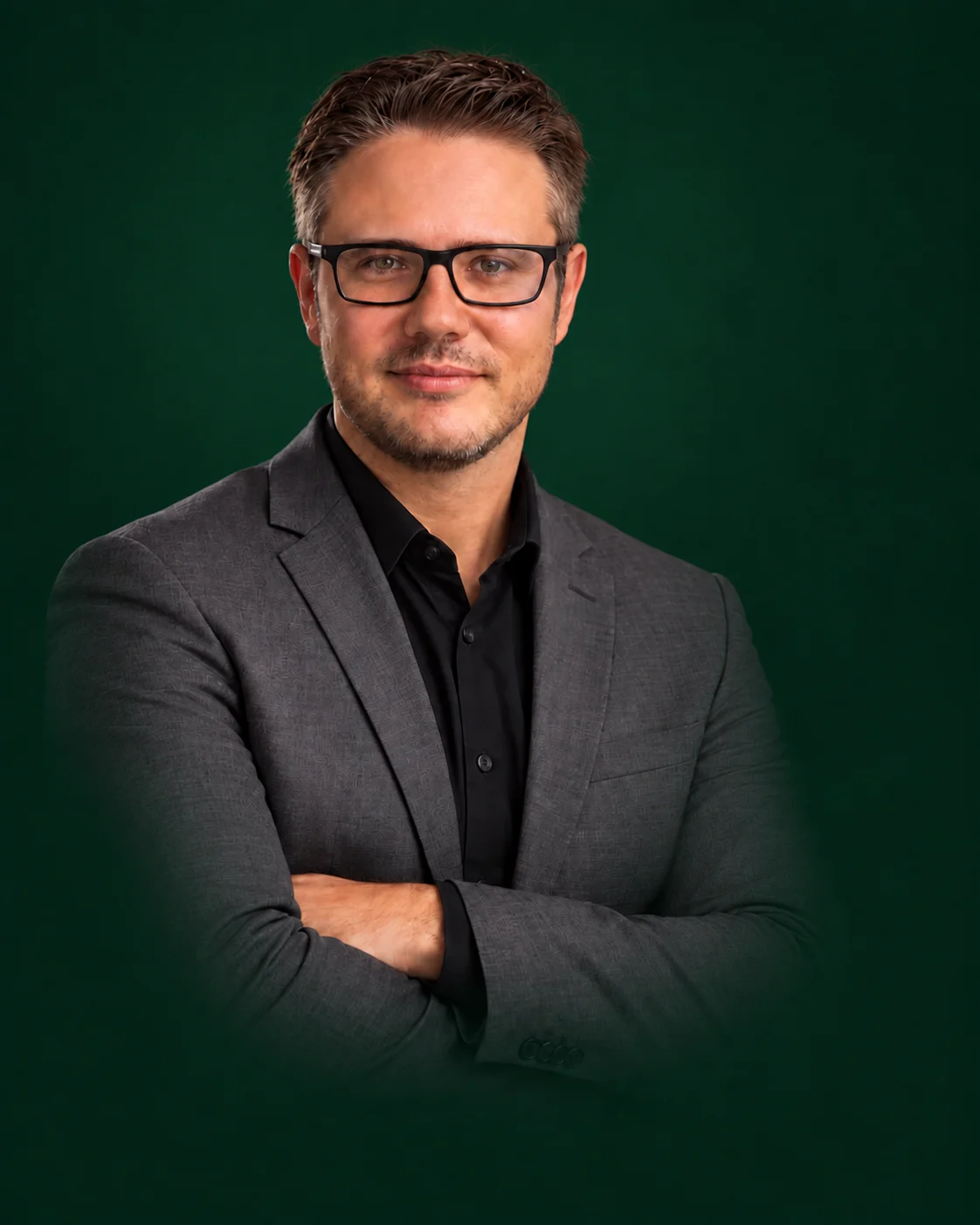 Gustavo Reichardt, founder of Gateway, in glasses, a grey blazer and black shirt, arms folded.
