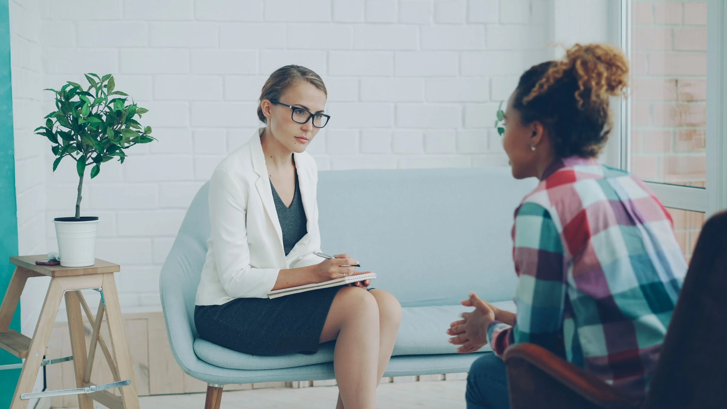 A healthcare professional listening to an adult patient during a private consultation