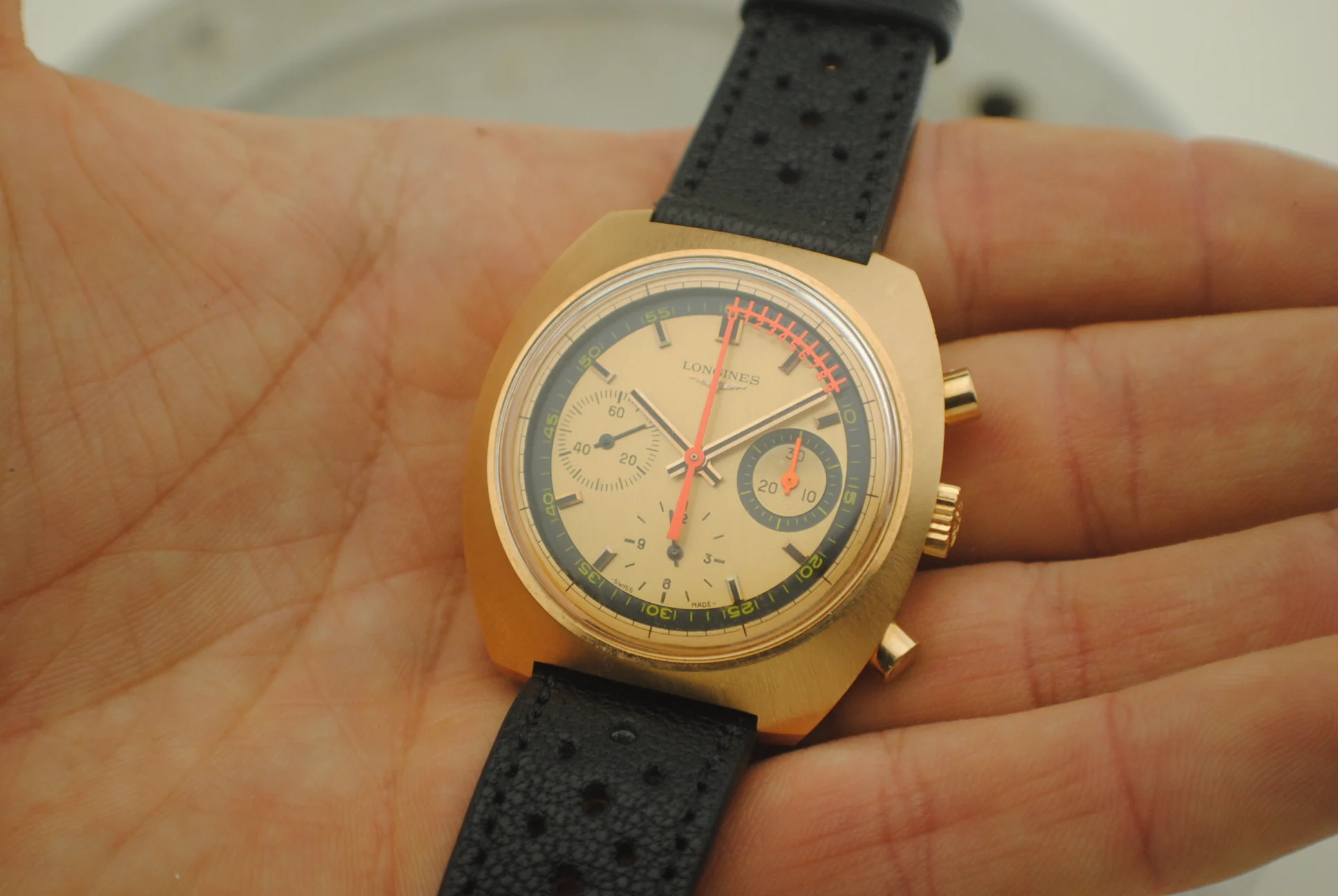 In-hand crystal-on view of the Longines Nonius dial and cushion-shaped case