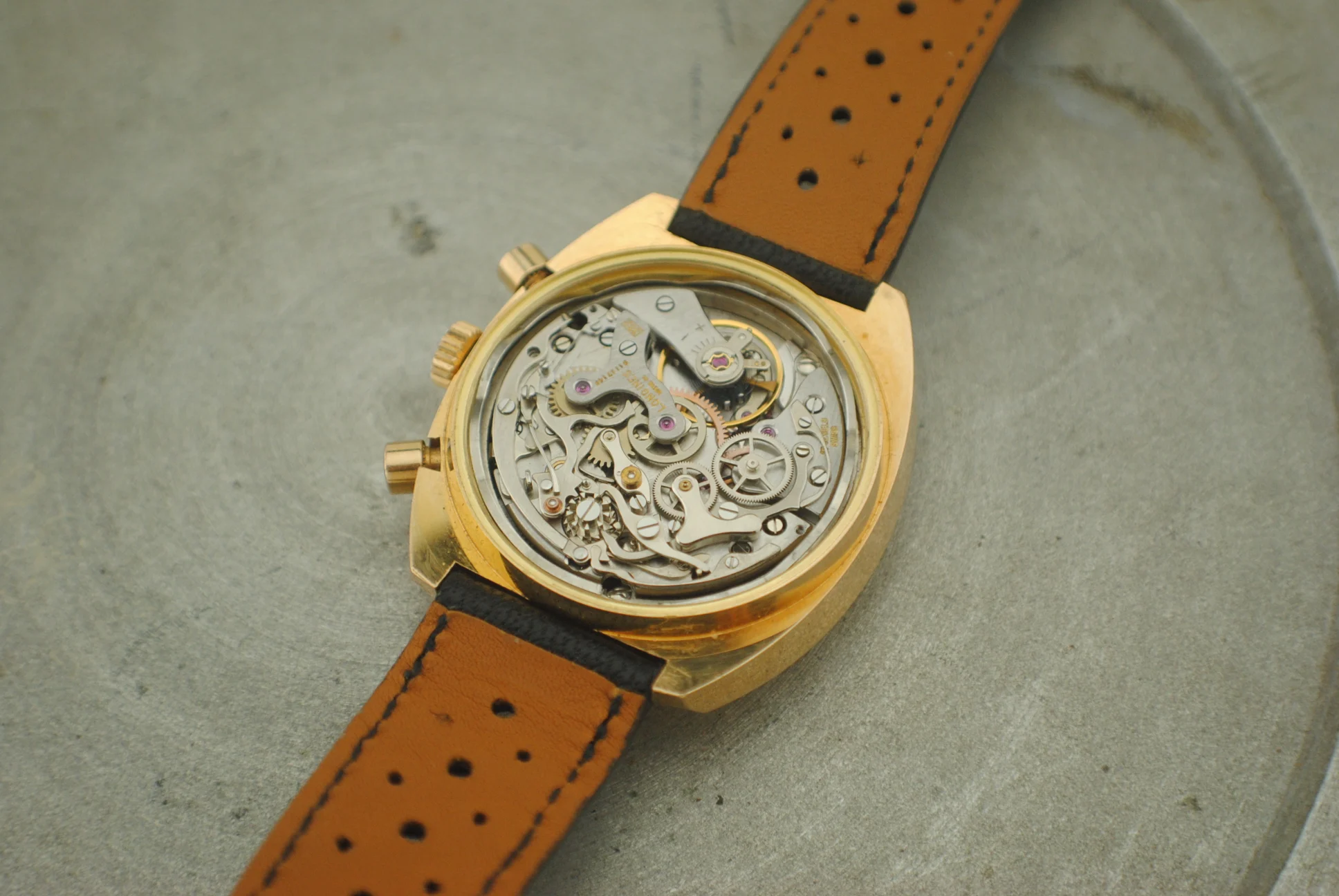Open Longines Nonius chronograph showing its mechanical movement