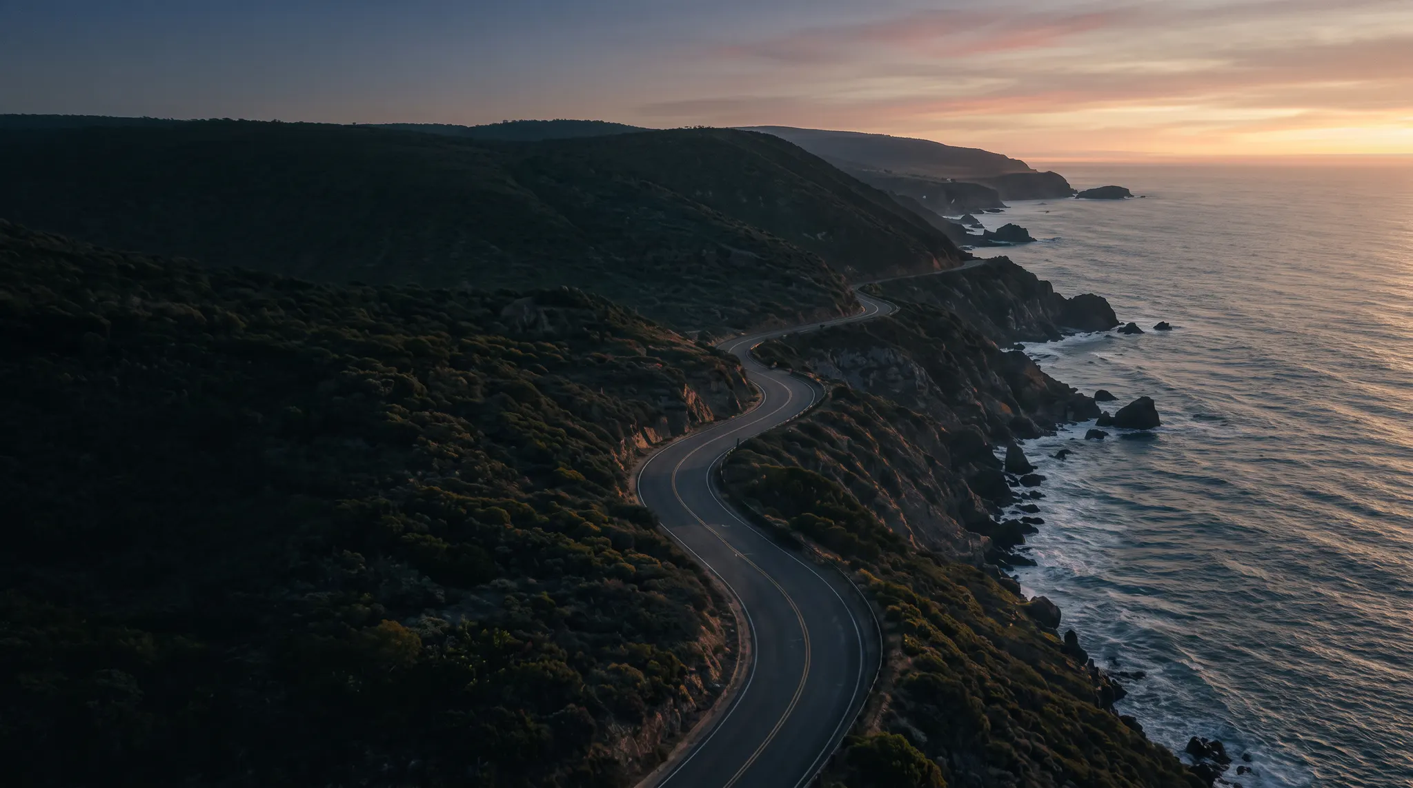 A winding road following the Australian coast at dawn