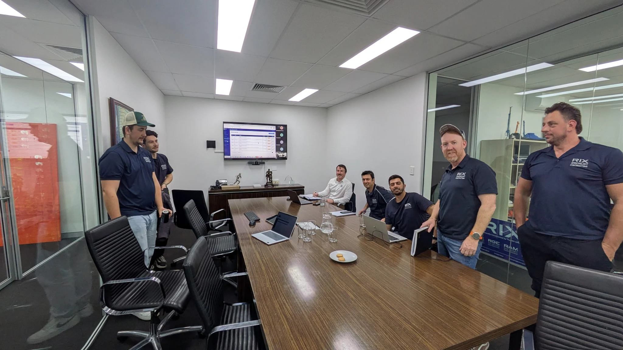 Construction team gathered around a table during a CAAi platform session