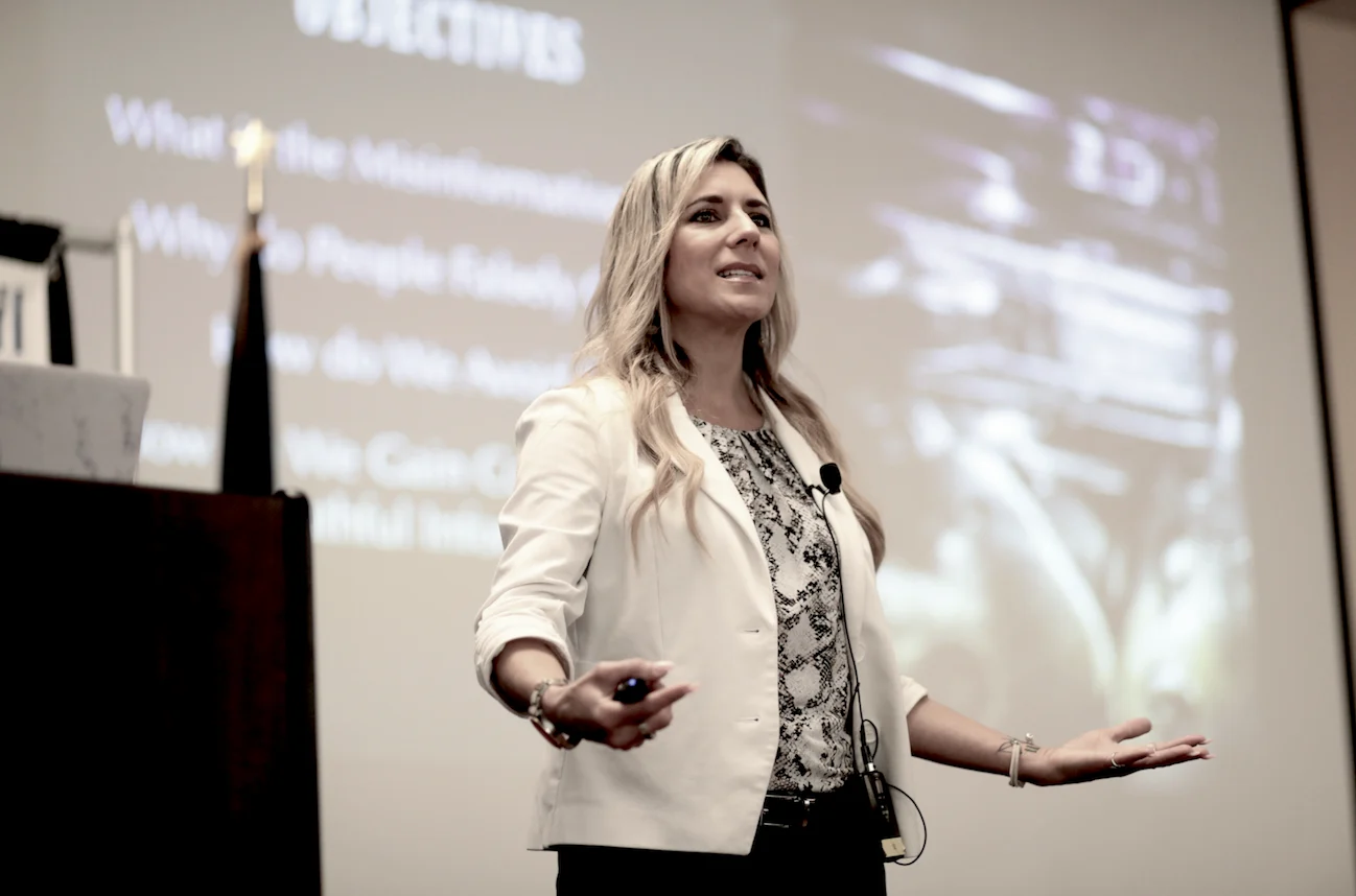 Lena Sisco speaking on stage to an audience