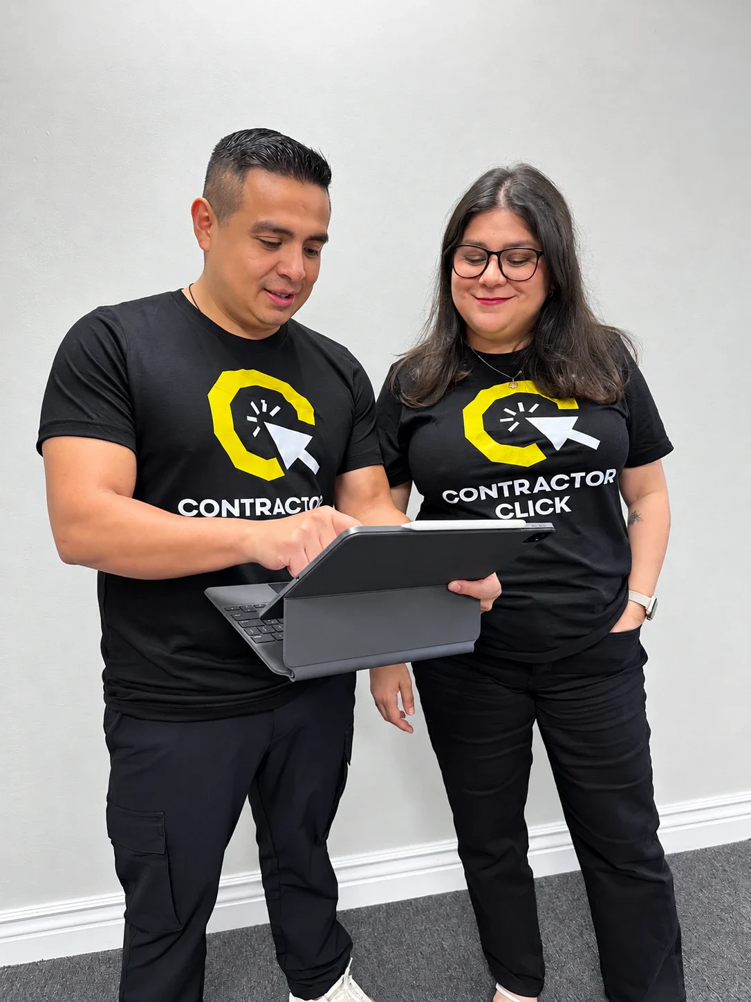 Danny and Mady Barrera reviewing work together on a tablet
