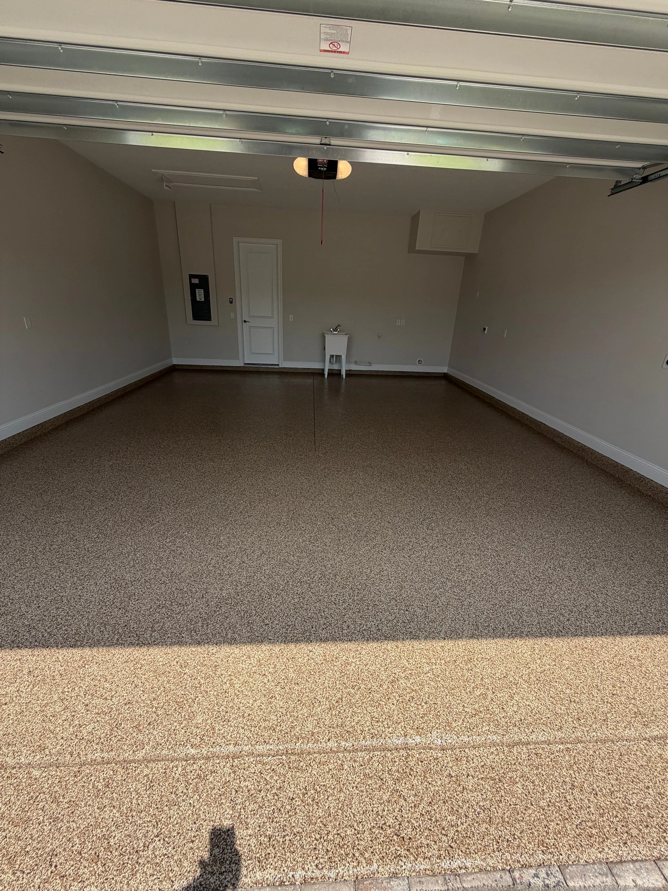 Finished tan and brown flake coating in a residential garage