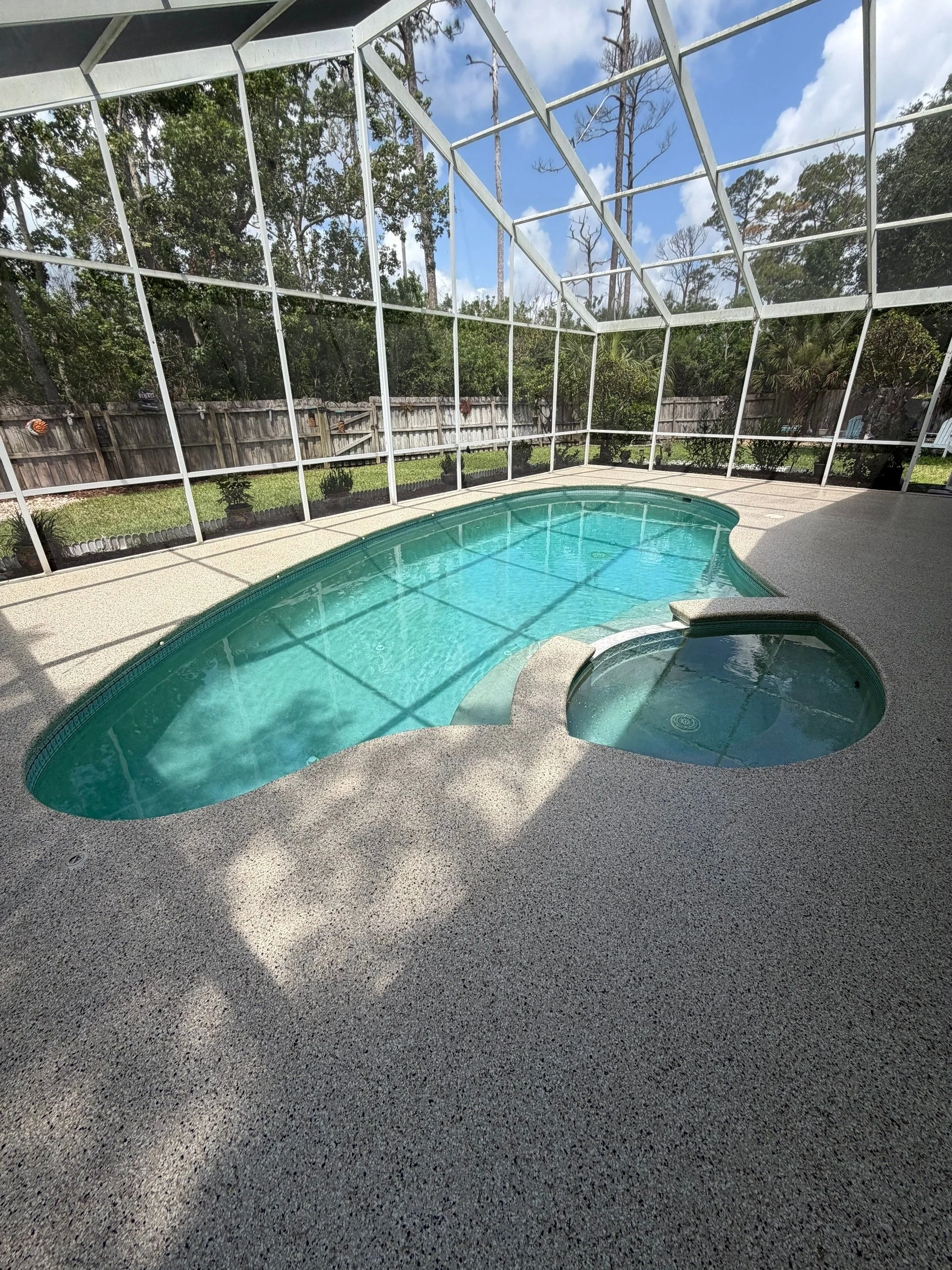Finished neutral flake coating around the same pool and spa