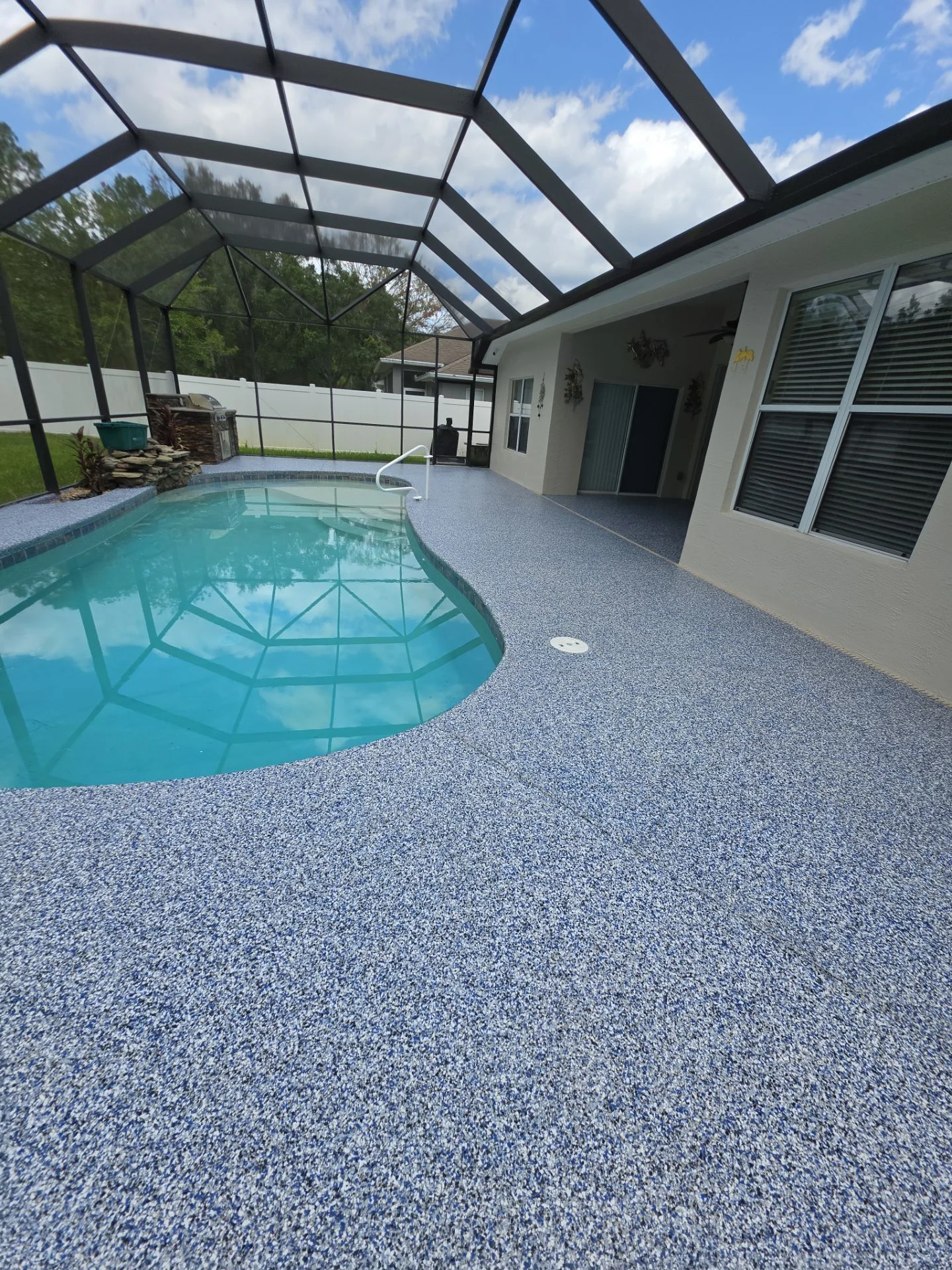 Finished blue and grey flake coating around the same pool