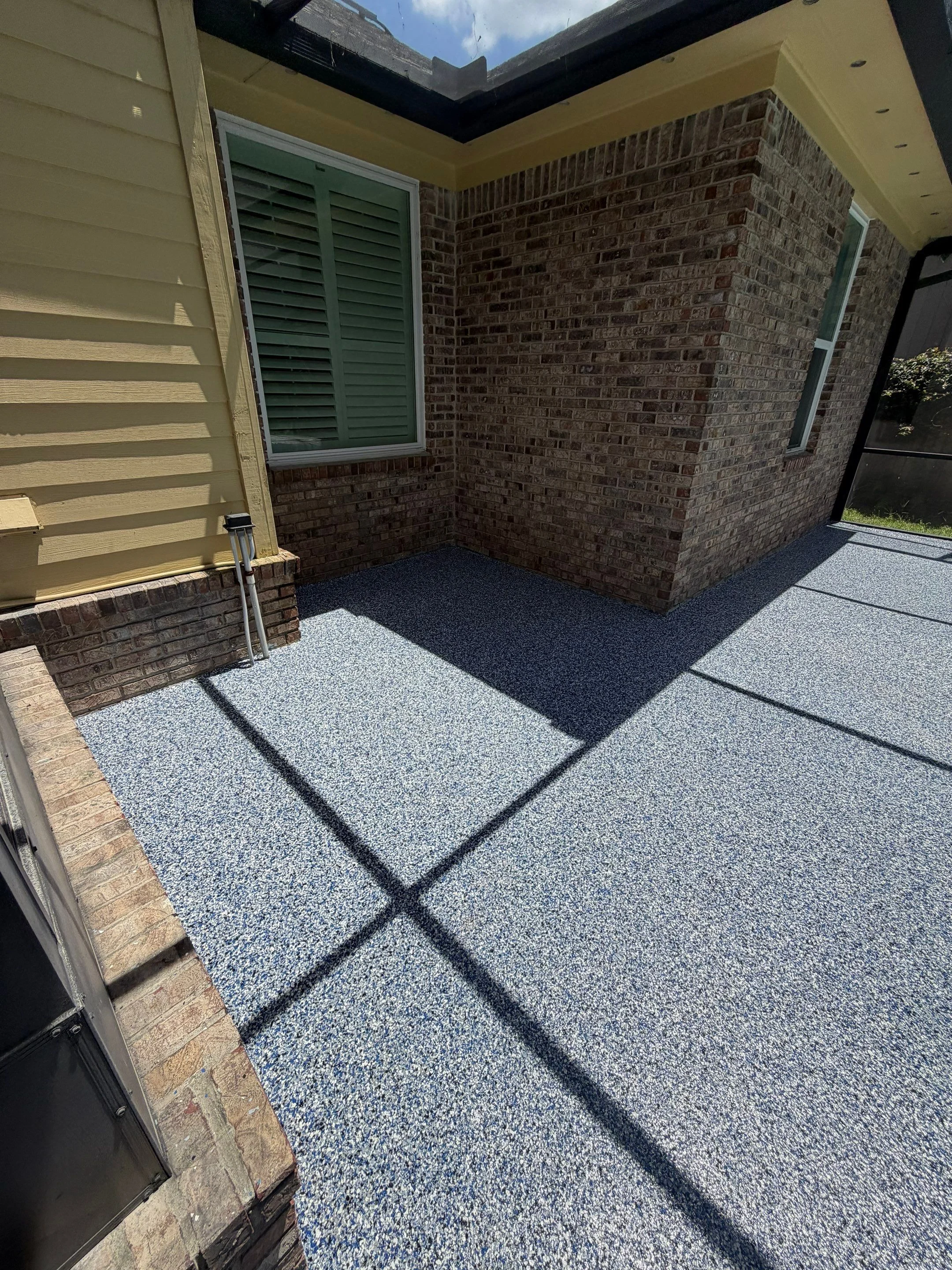 Finished blue and grey flake coating on a residential patio