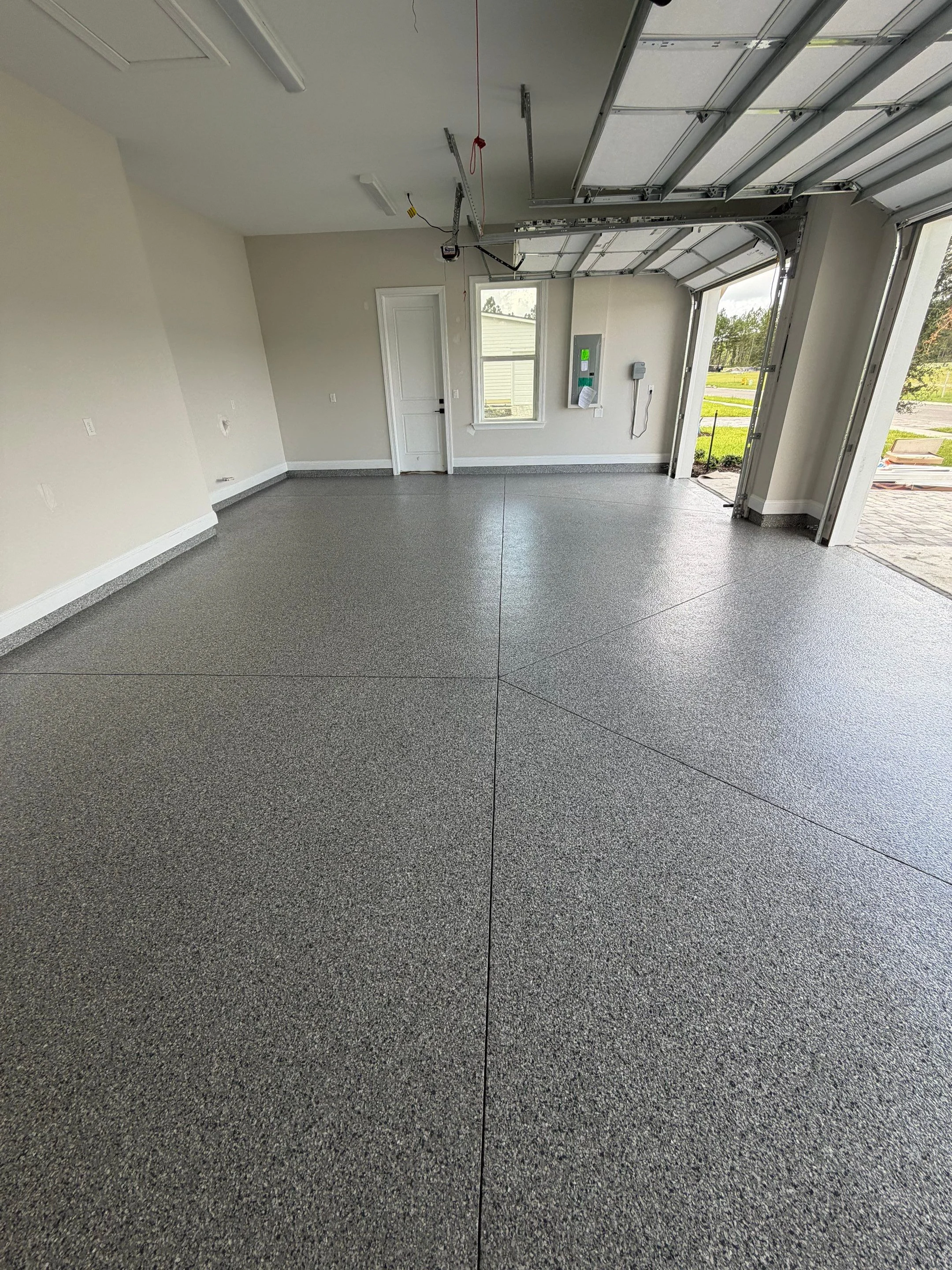 Finished grey flake coating in a bright residential garage