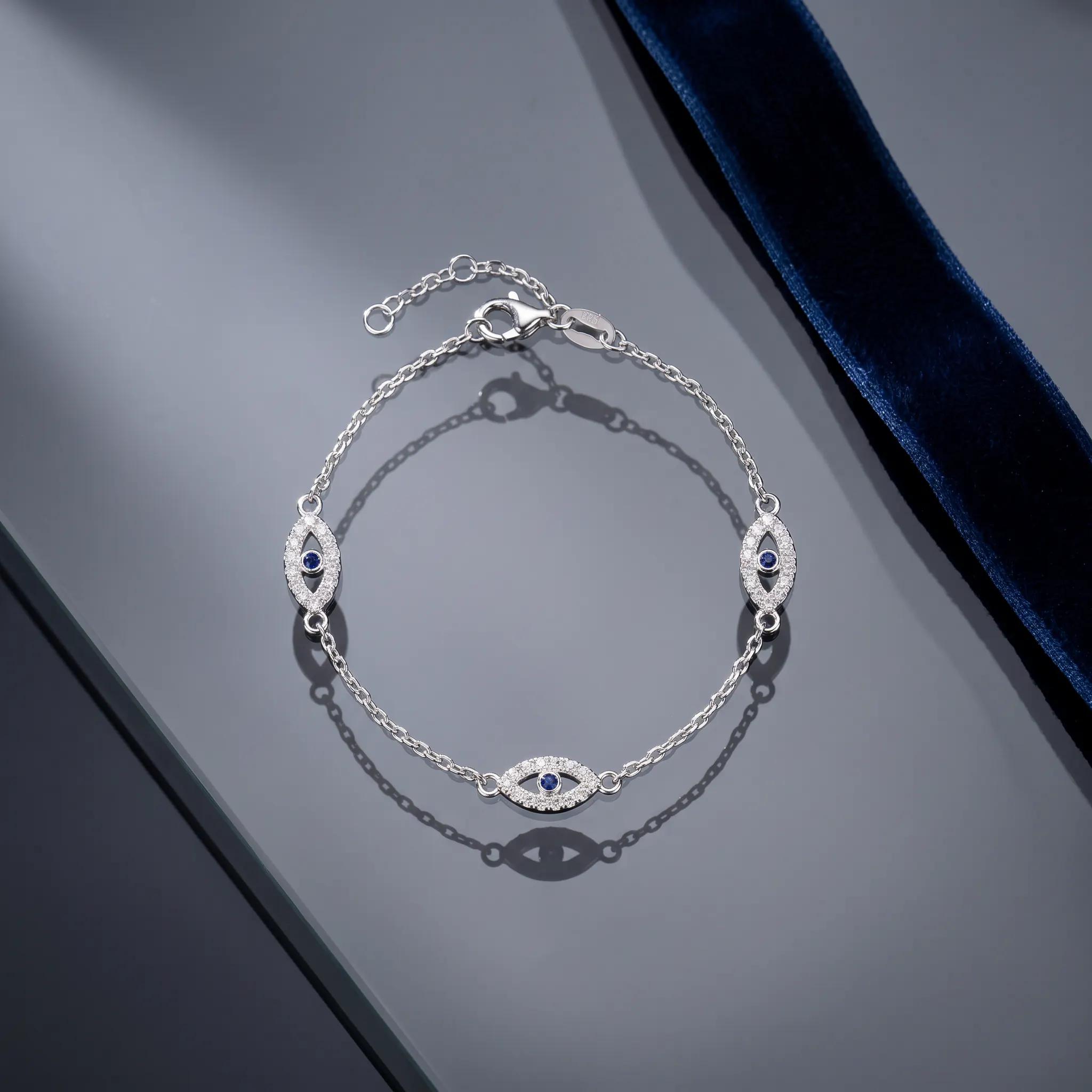 CHOODO Evil Eyes sterling silver bracelet on smoky glass and deep blue velvet