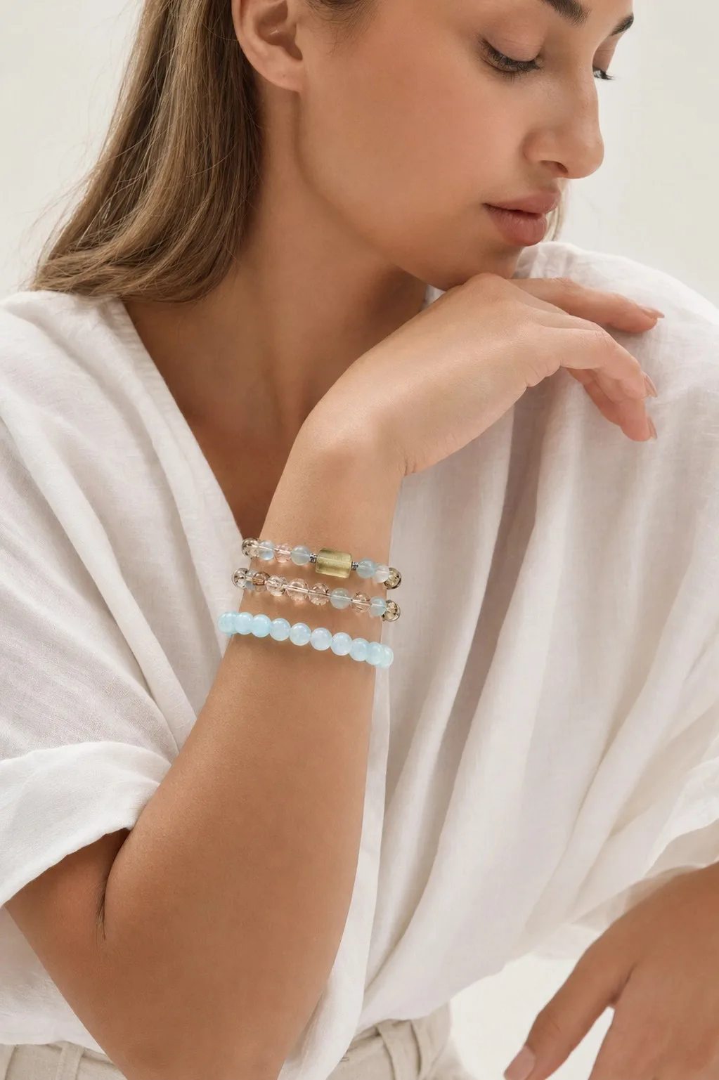 Instagram post with the caption: Layering is made effortless. 🌊\n\n #AestheticJewelry #NaturalGems...