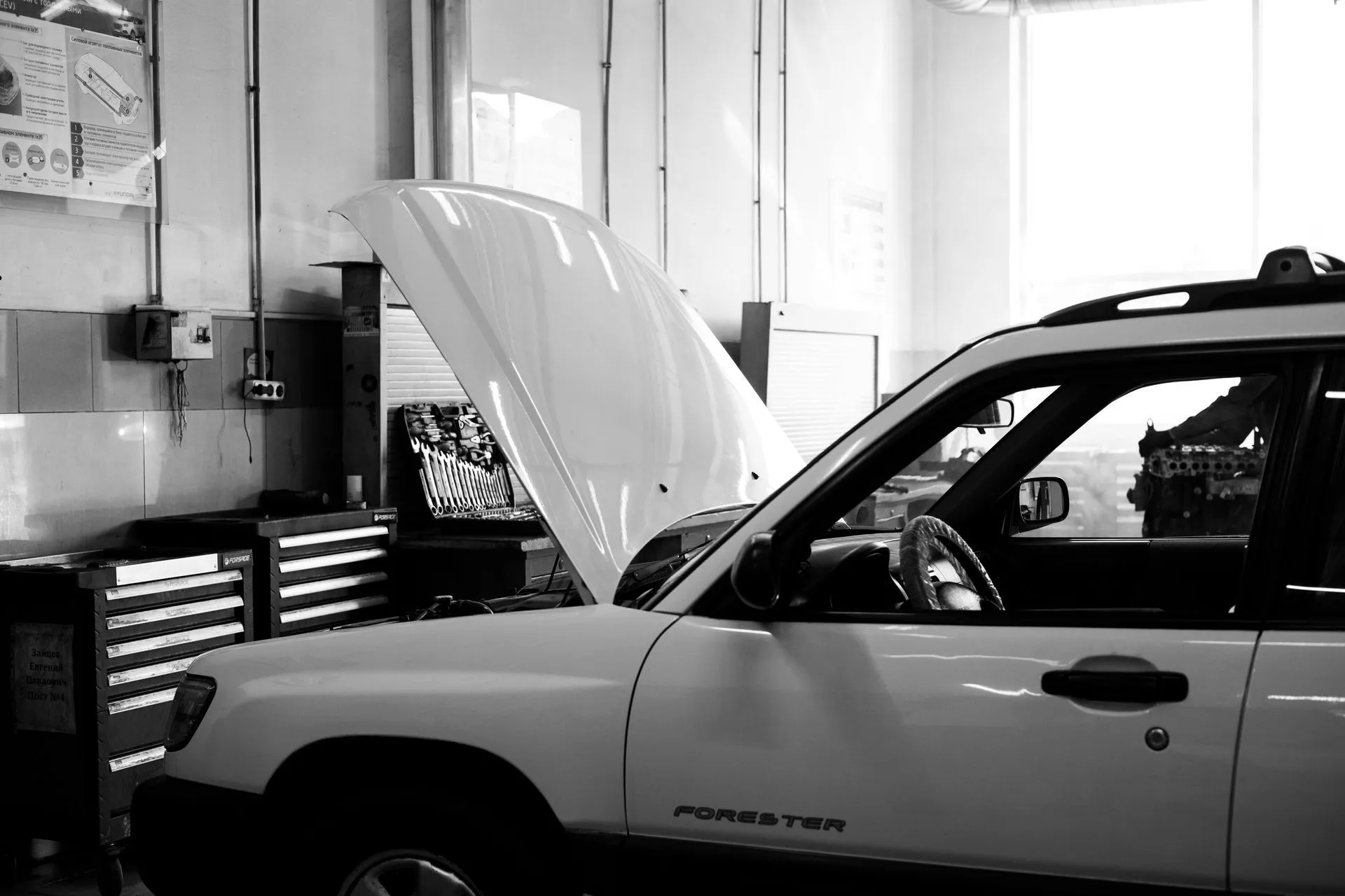 Technician working under the hood of a vehicle