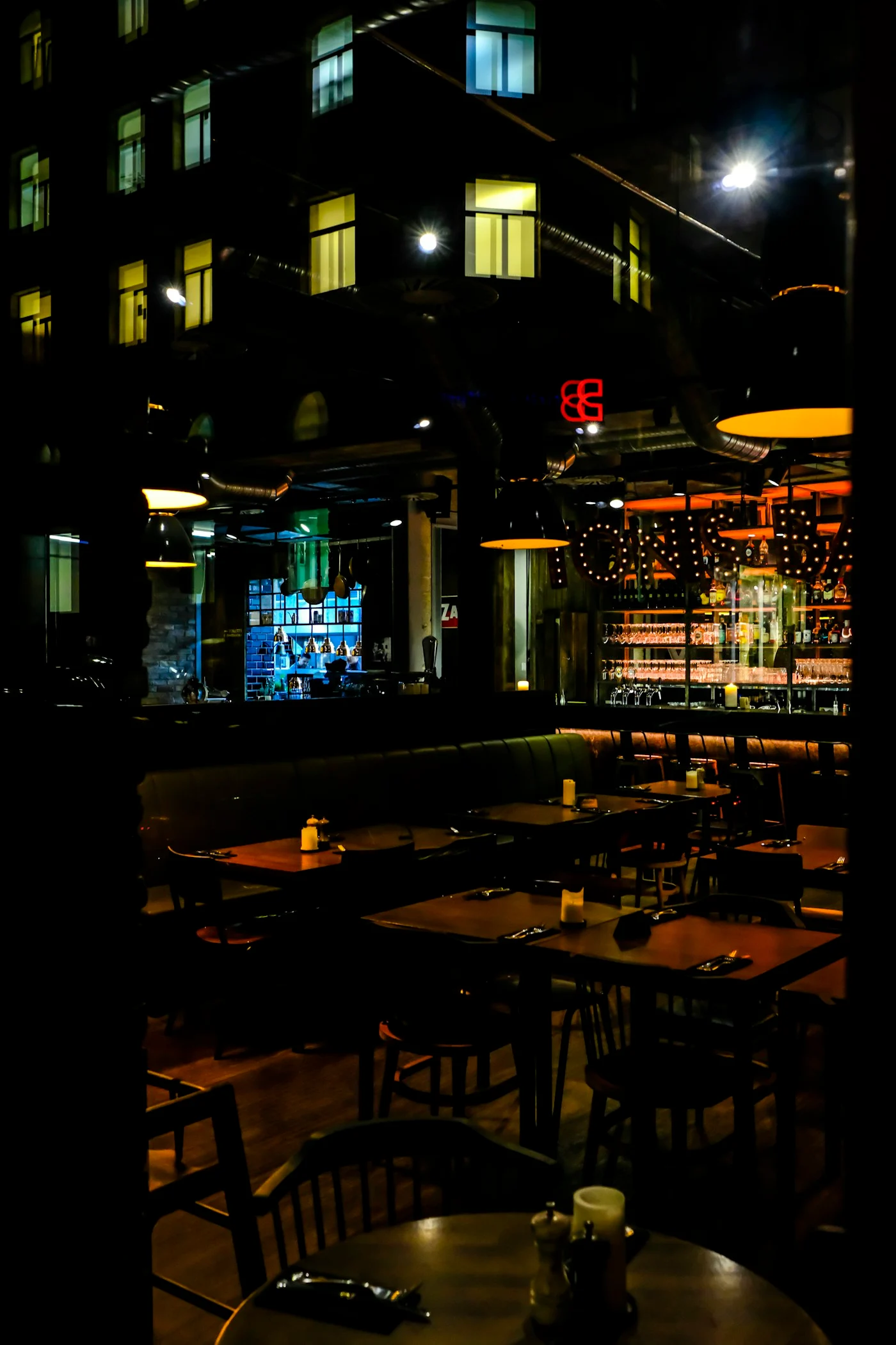 Dimly lit tables and bar inside Travolta Bar in Nuremberg