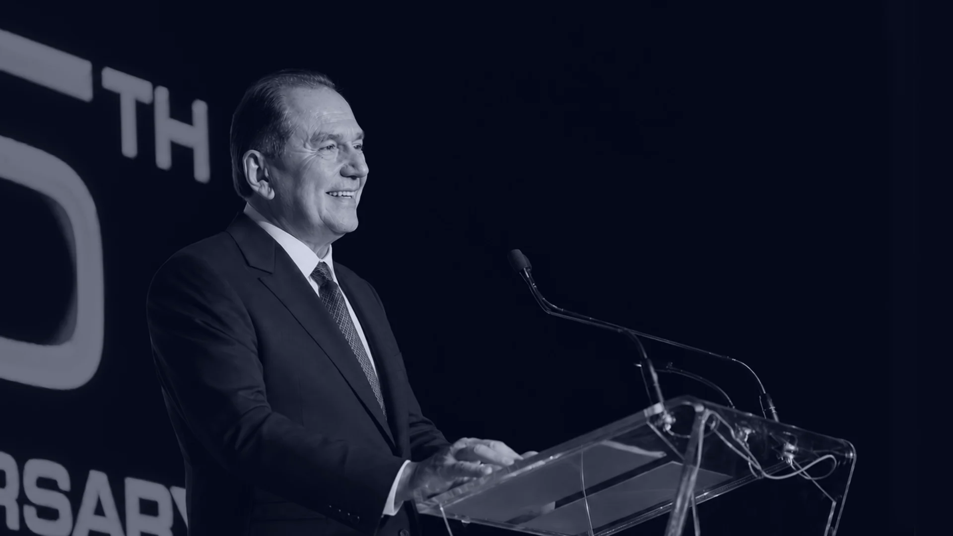 Daniel Argiros, CEO of Conundrum Capital Corporation, speaking at a lectern