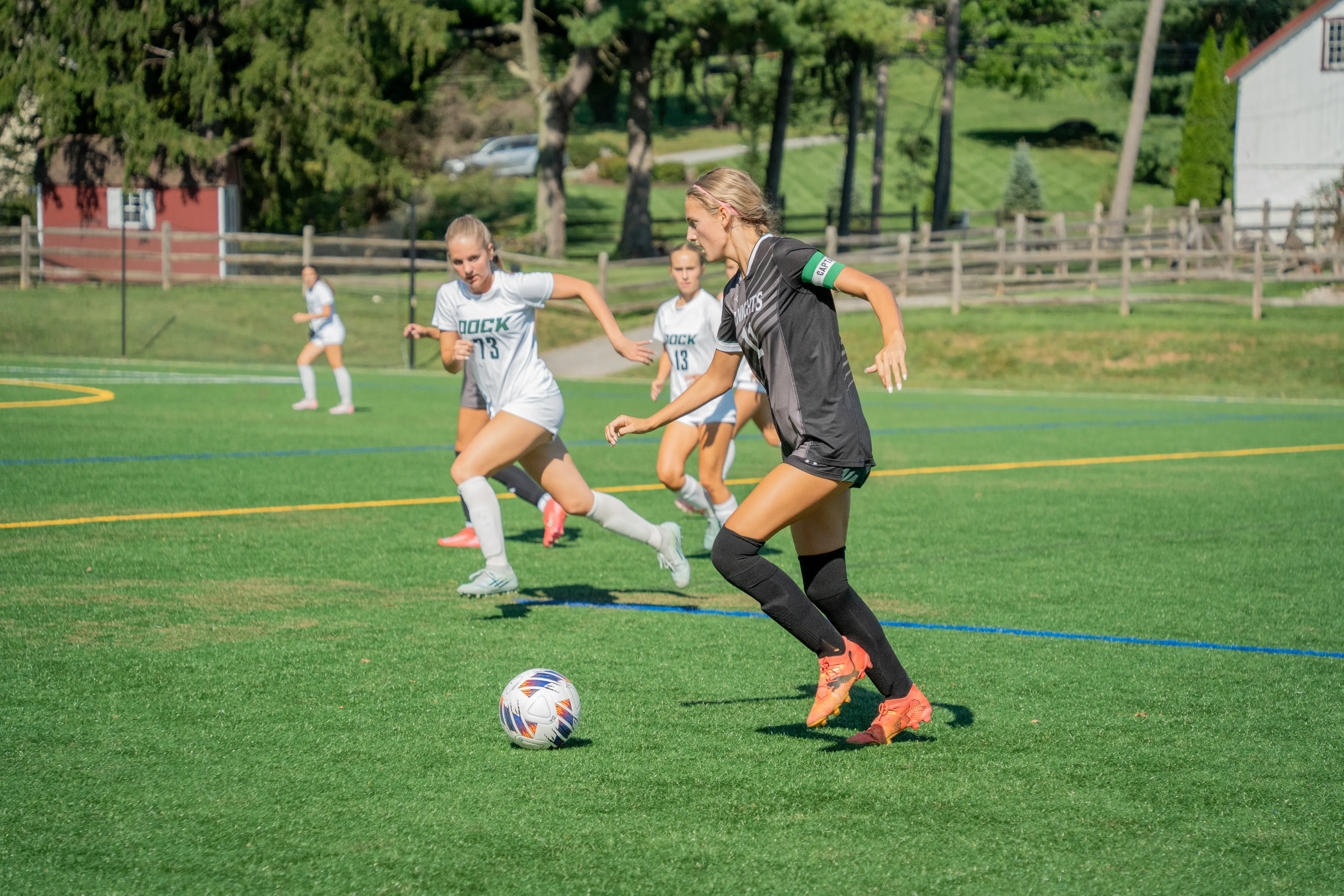 Soccer captain dribbling as opponents approach