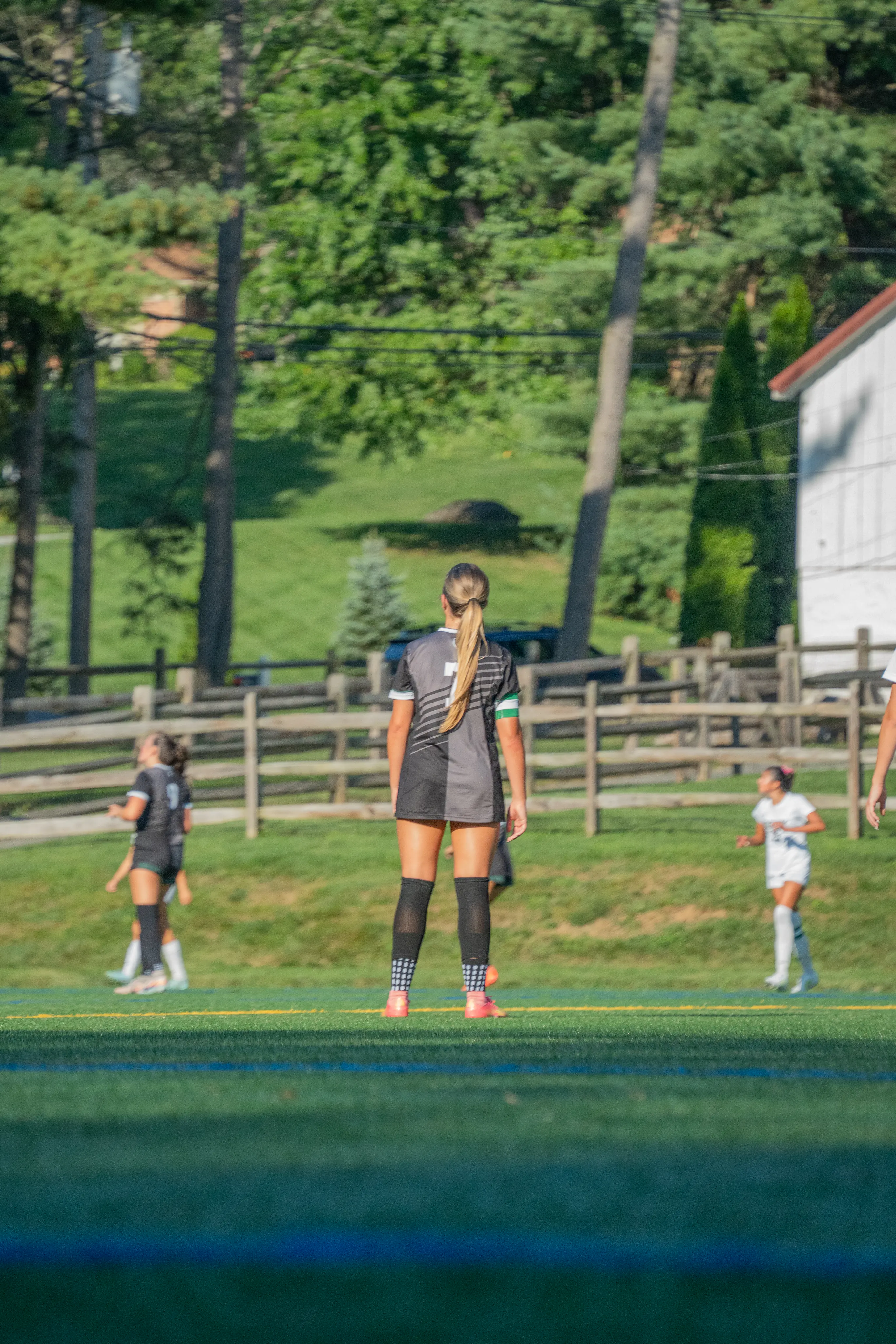 Soccer captain watching play from the field