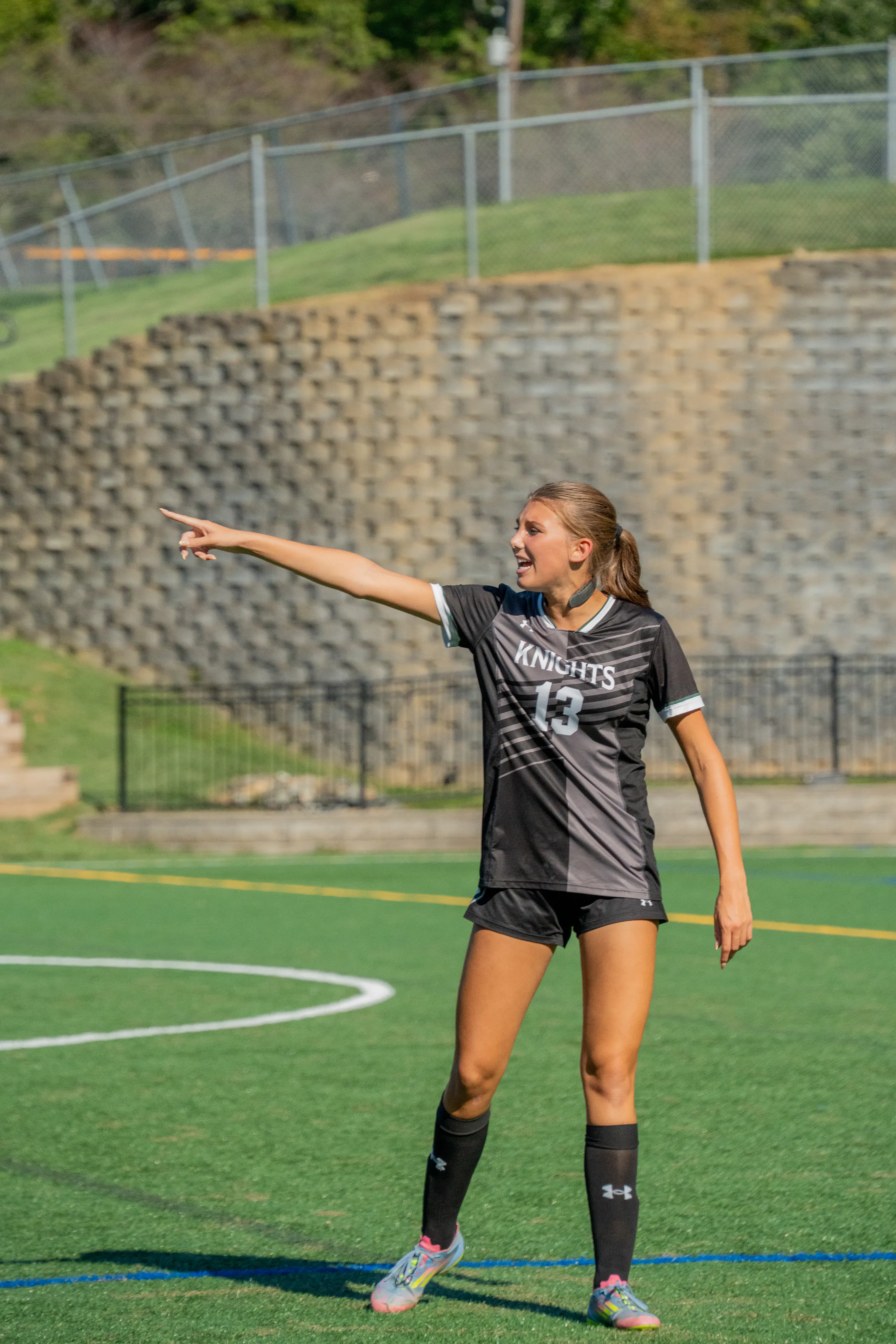 Soccer player number 13 directing play across the field