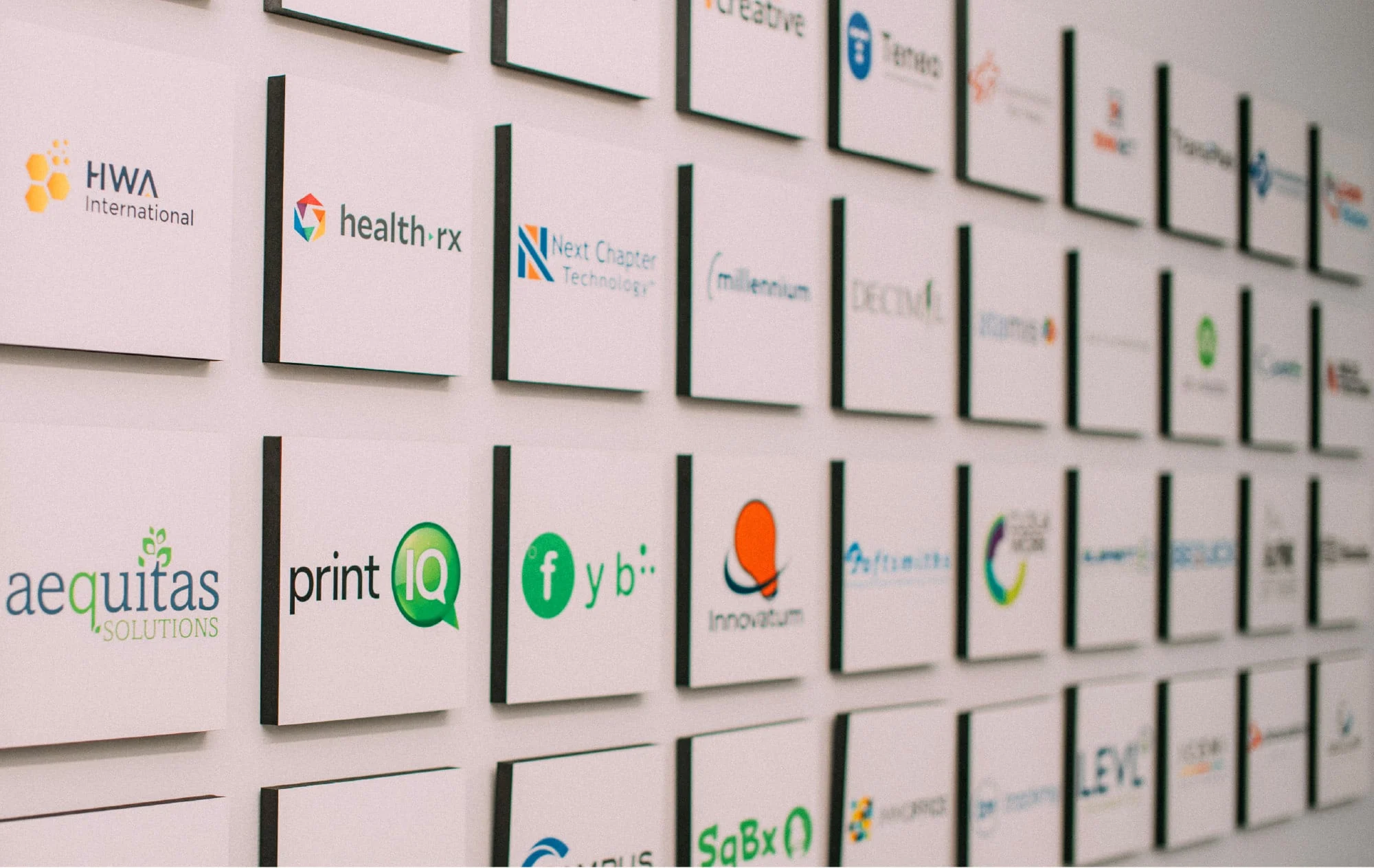 A wall displaying logos from Banyan Software companies