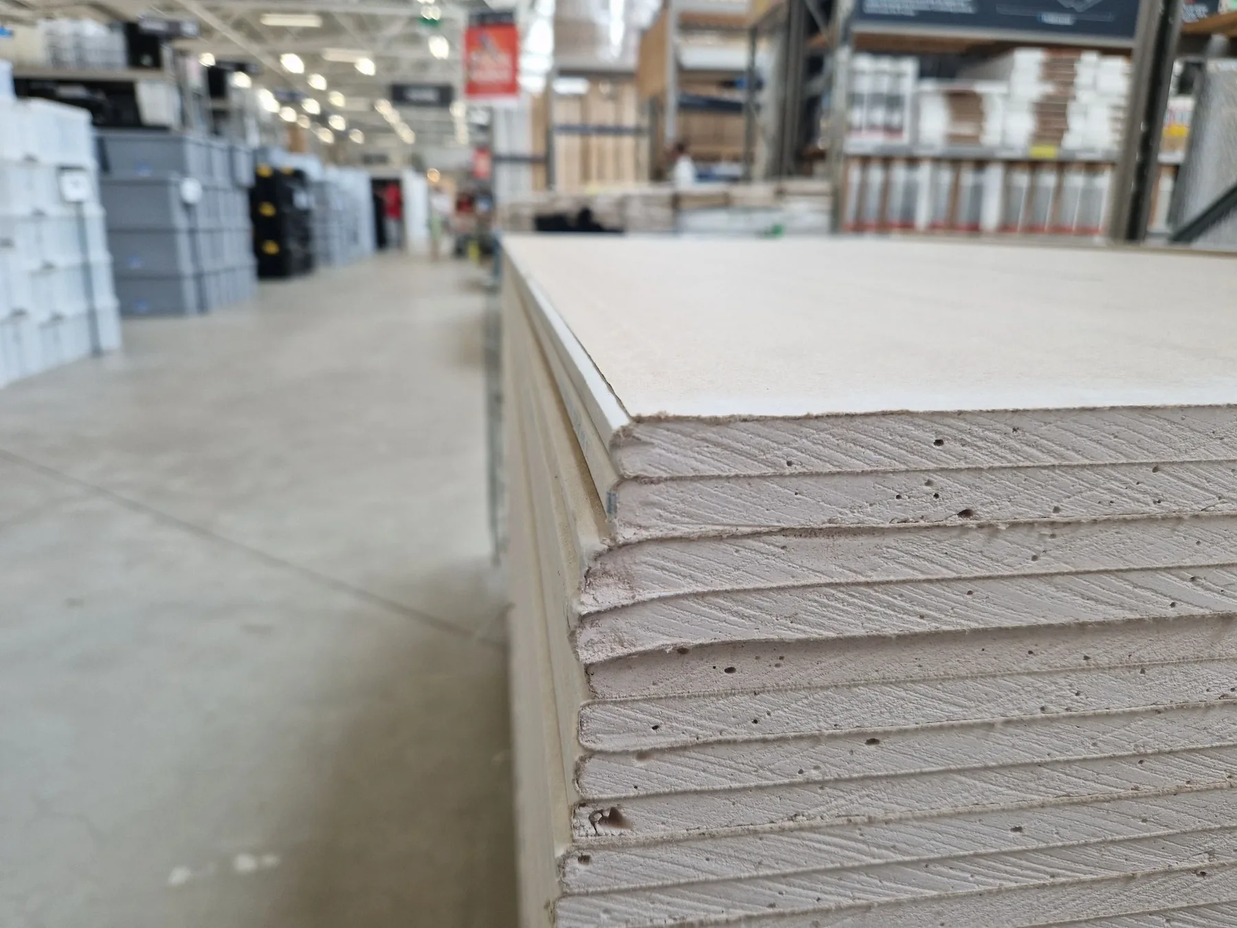 Stock photo of plasterboard sheets stacked in a building-supply warehouse