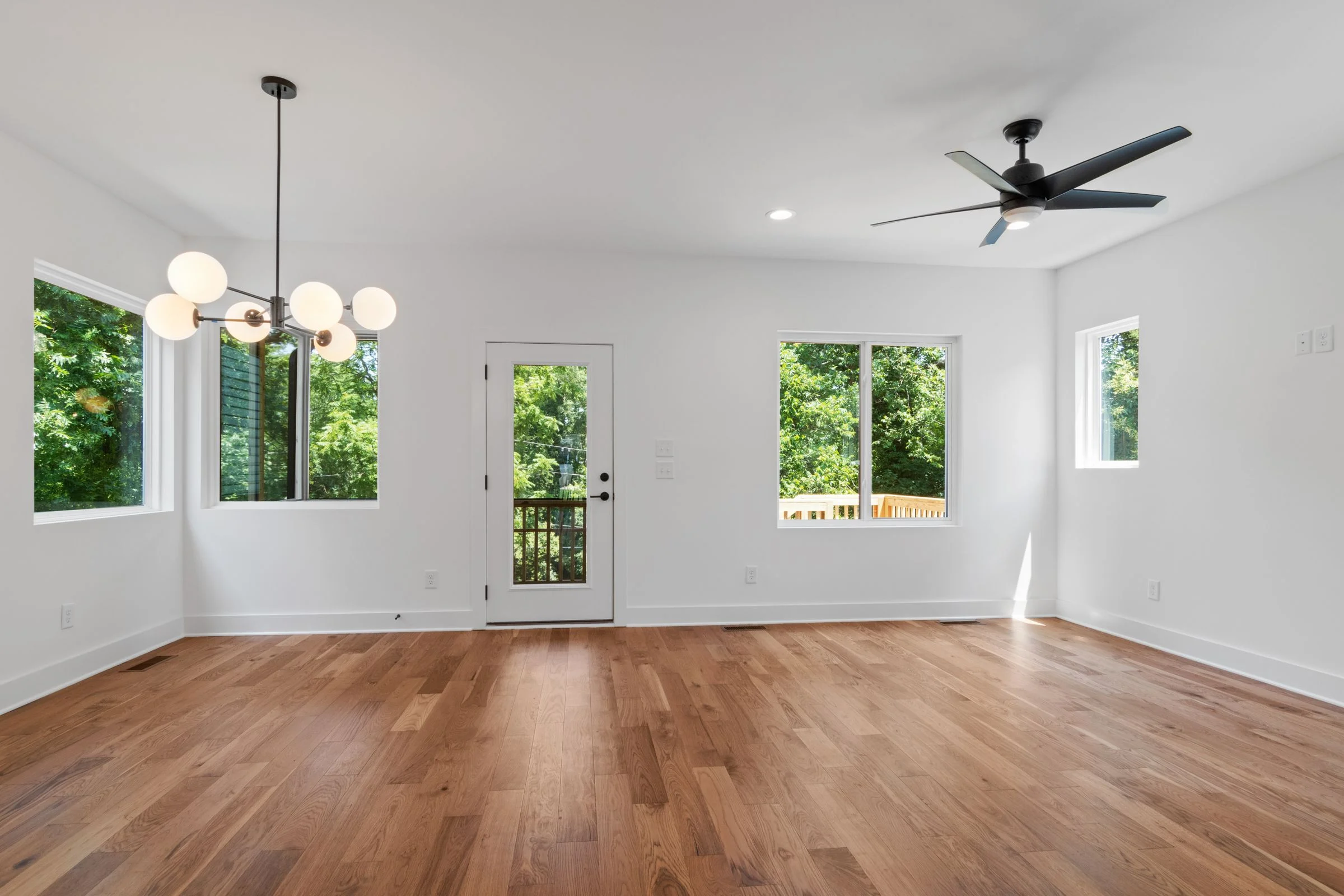 Stock photo of a residential interior with white-framed windows and a glazed exterior door