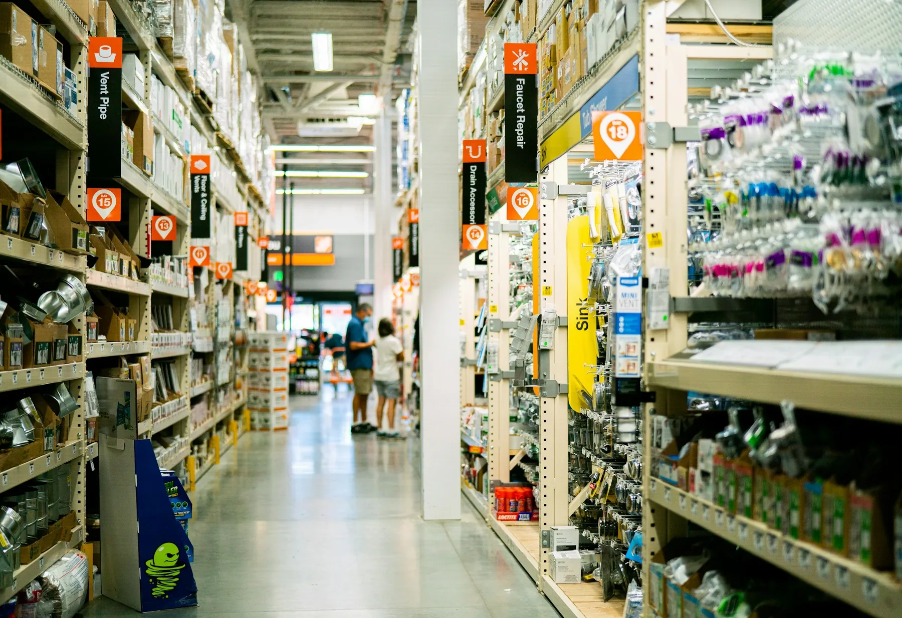 Stock photo of a hardware-store aisle with plumbing fittings and stocked shelves