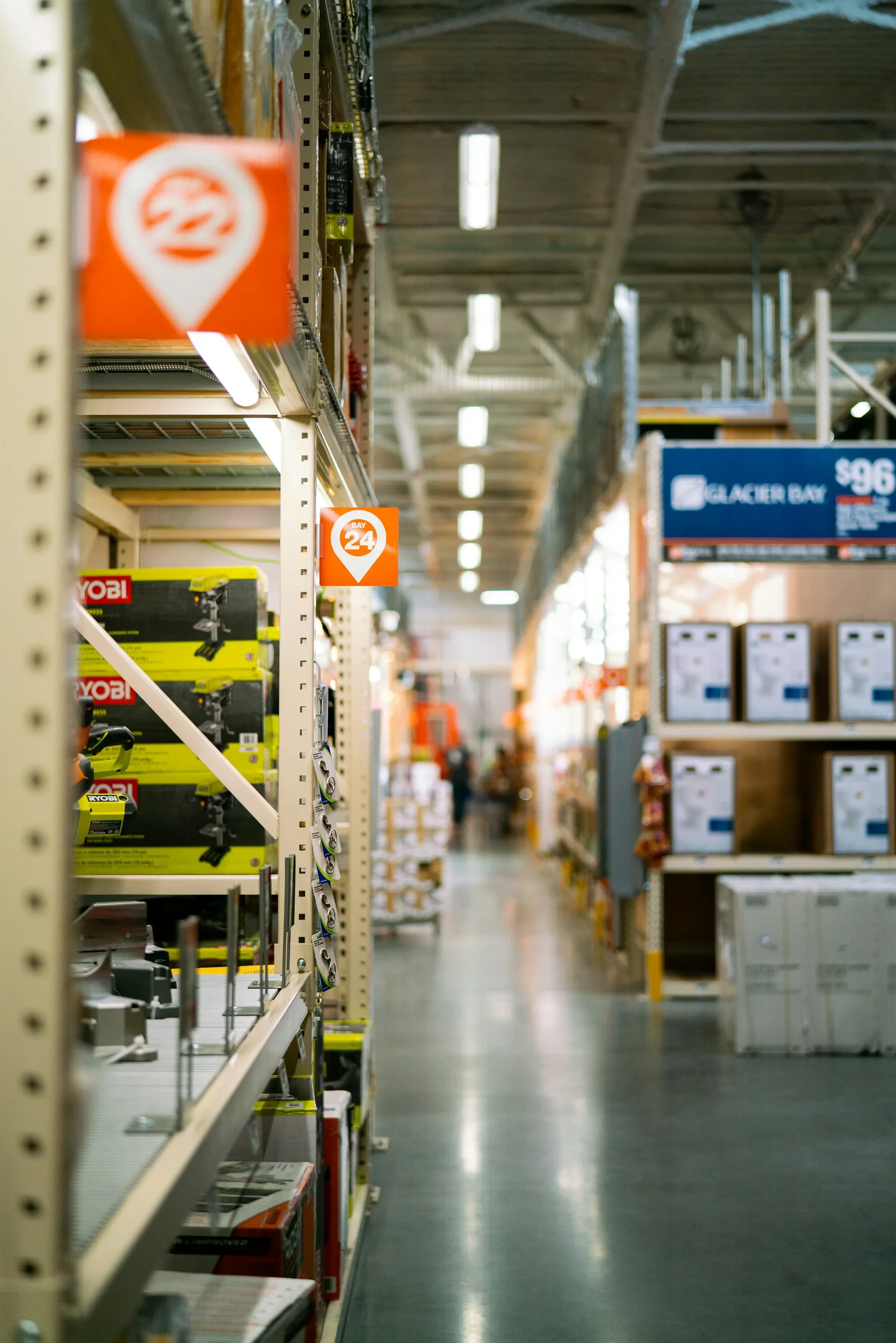 Stock photo of a hardware-store aisle with boxed power tools and shelving