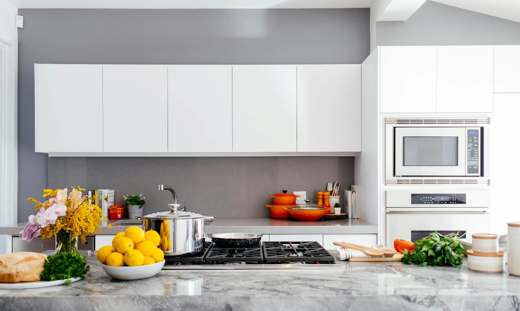 Representative bright kitchen with a stone island and active cooking space