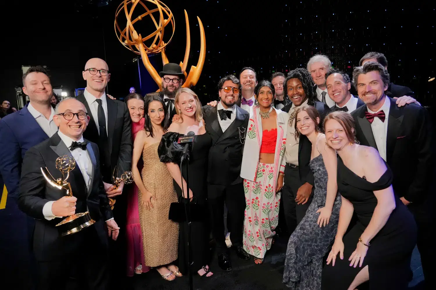 The Late Show team celebrating its 2026 Emmy wins with Emmy statuettes