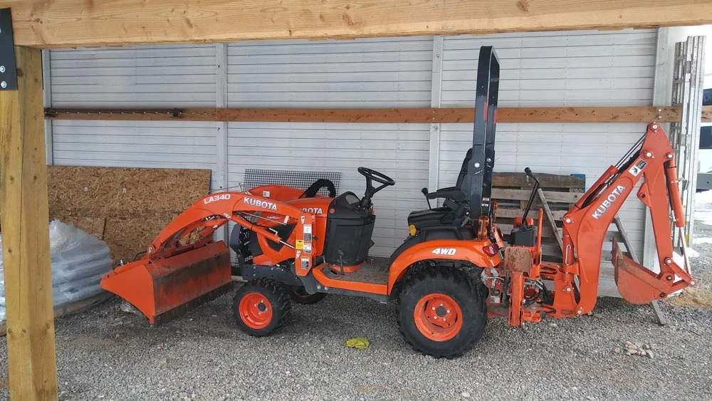 Compact tractor with front loader and backhoe