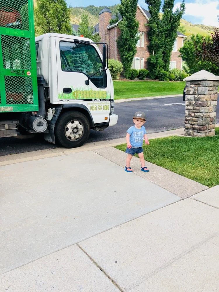 Greenscapes branded box truck parked on a residential street