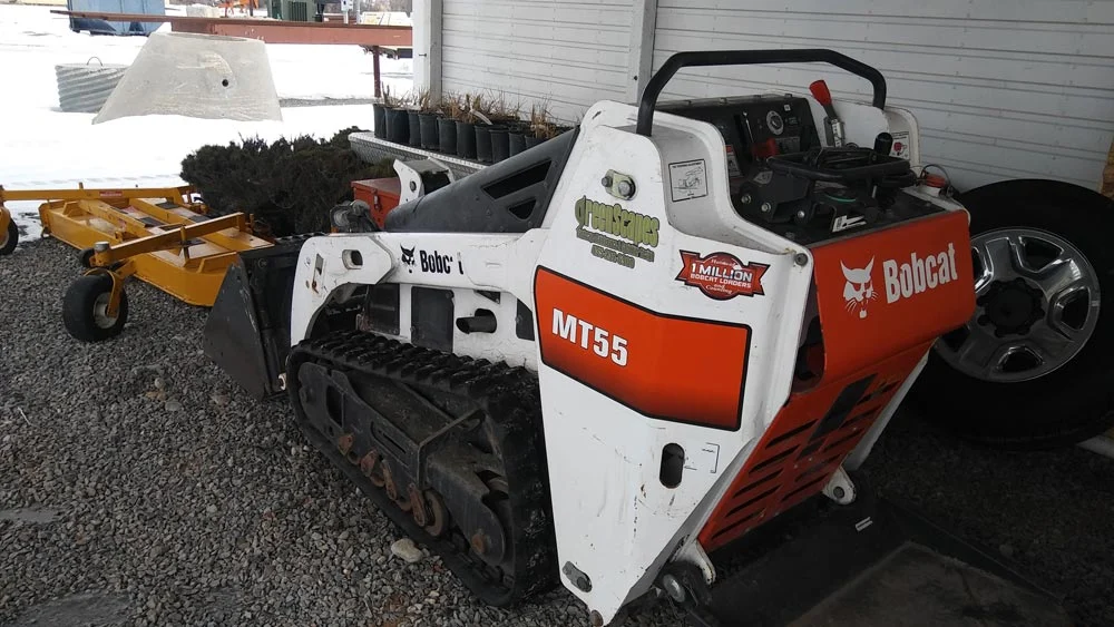 Greenscapes Bobcat mini track loader with attachments