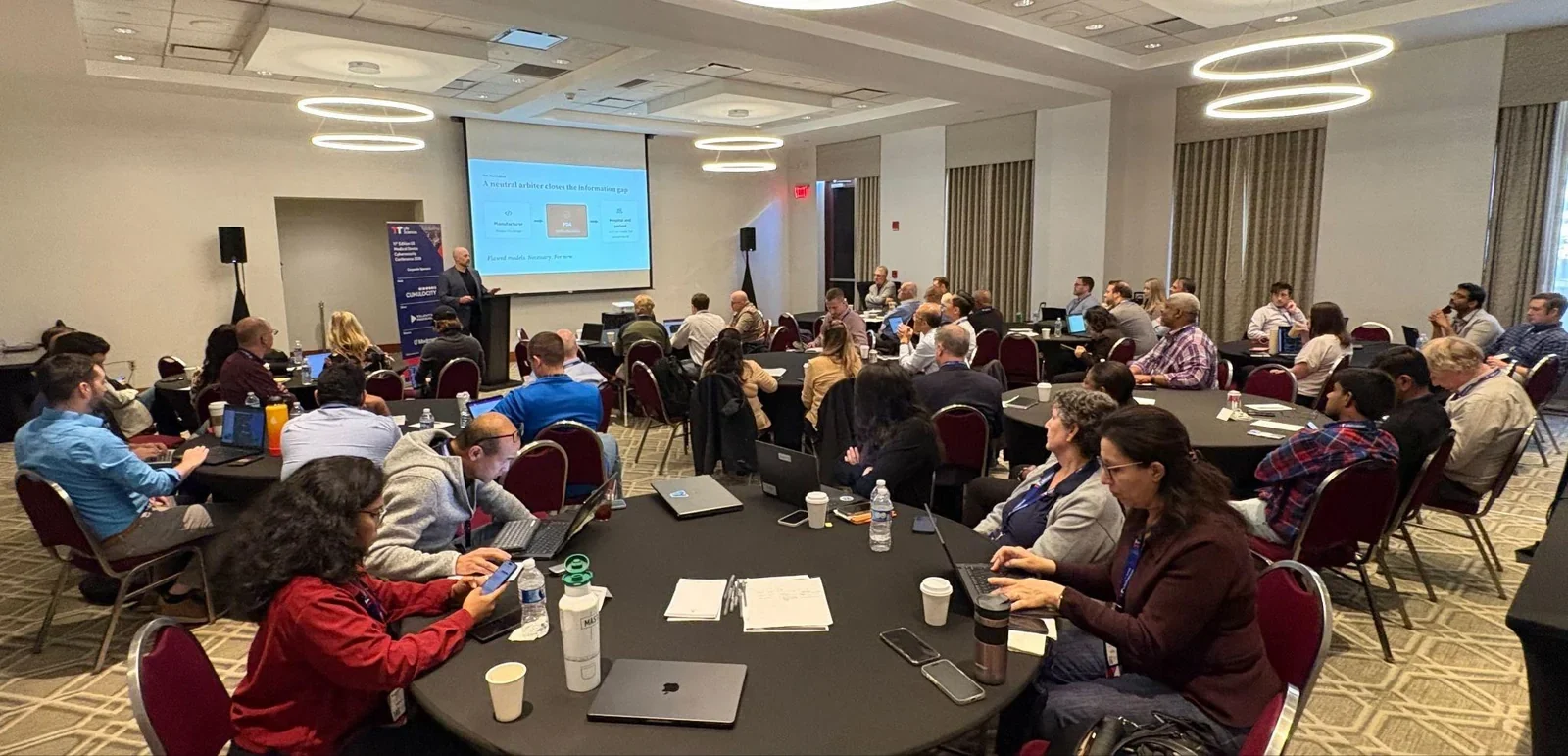 Attendees at round tables during a session at the 2026 US Medical Device Cybersecurity Conference in Boston