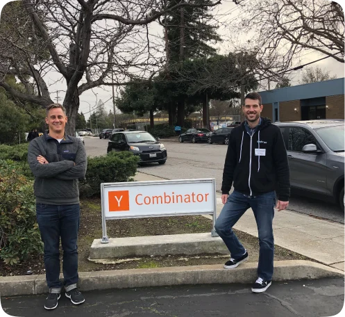 Medcrypt founders standing beside the Y Combinator sign