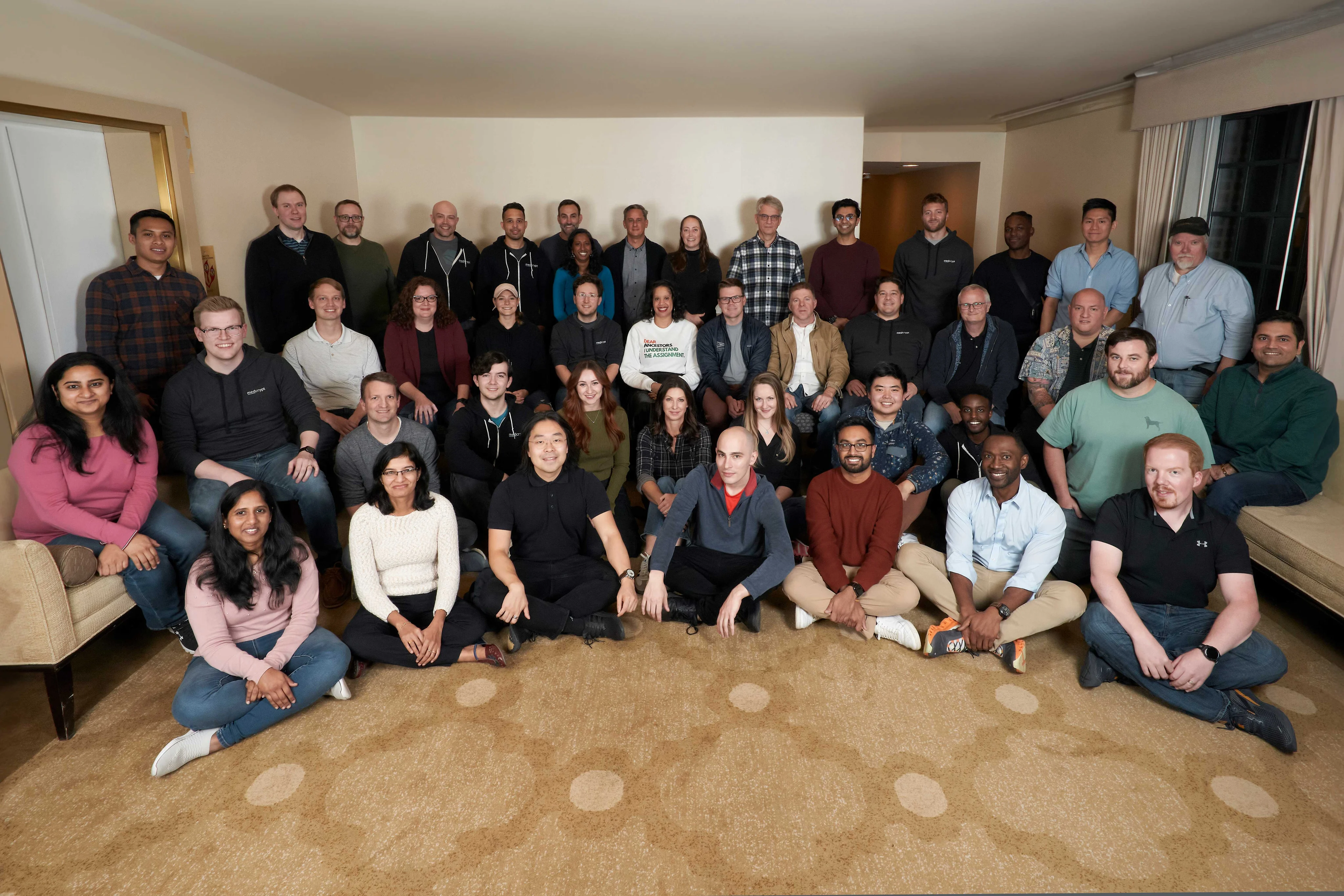 Large group of Medcrypt colleagues gathered indoors