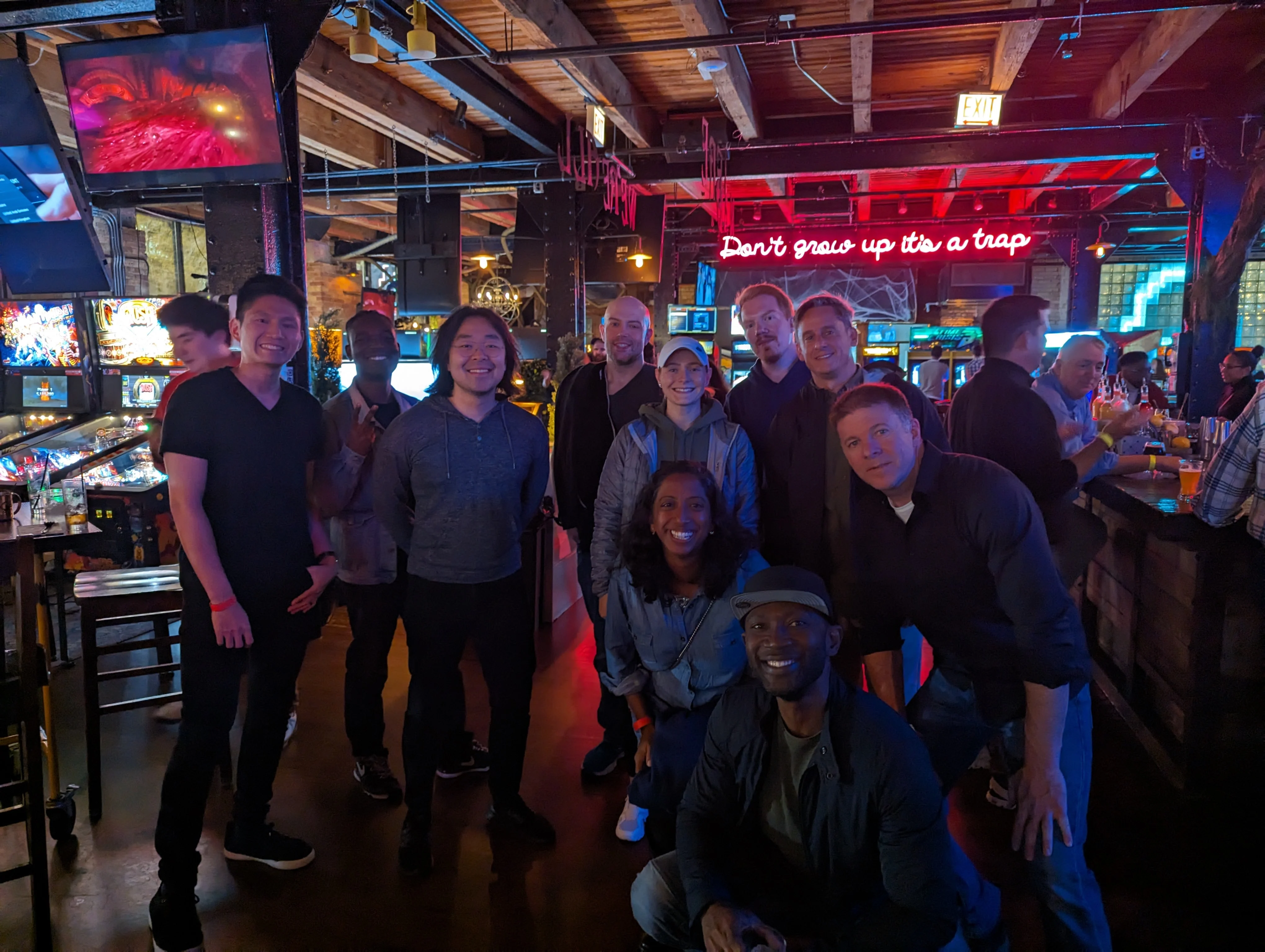 Medcrypt team gathered at an arcade bar