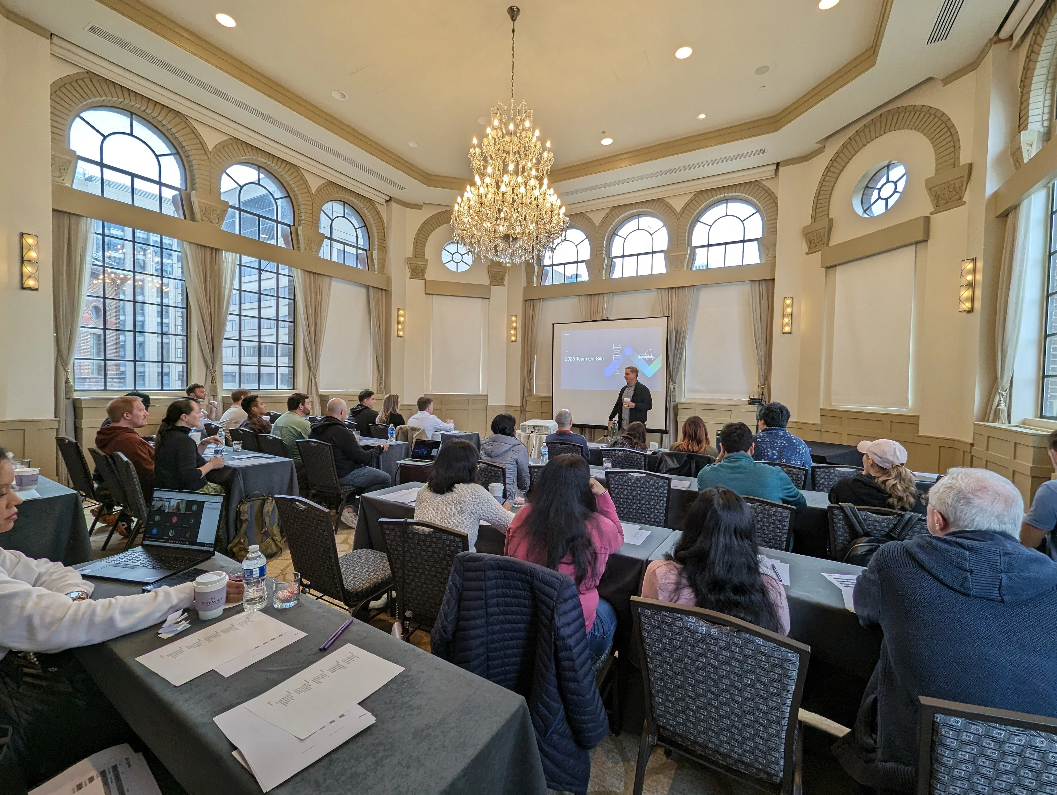 Medcrypt team attending a company presentation in an elegant hall