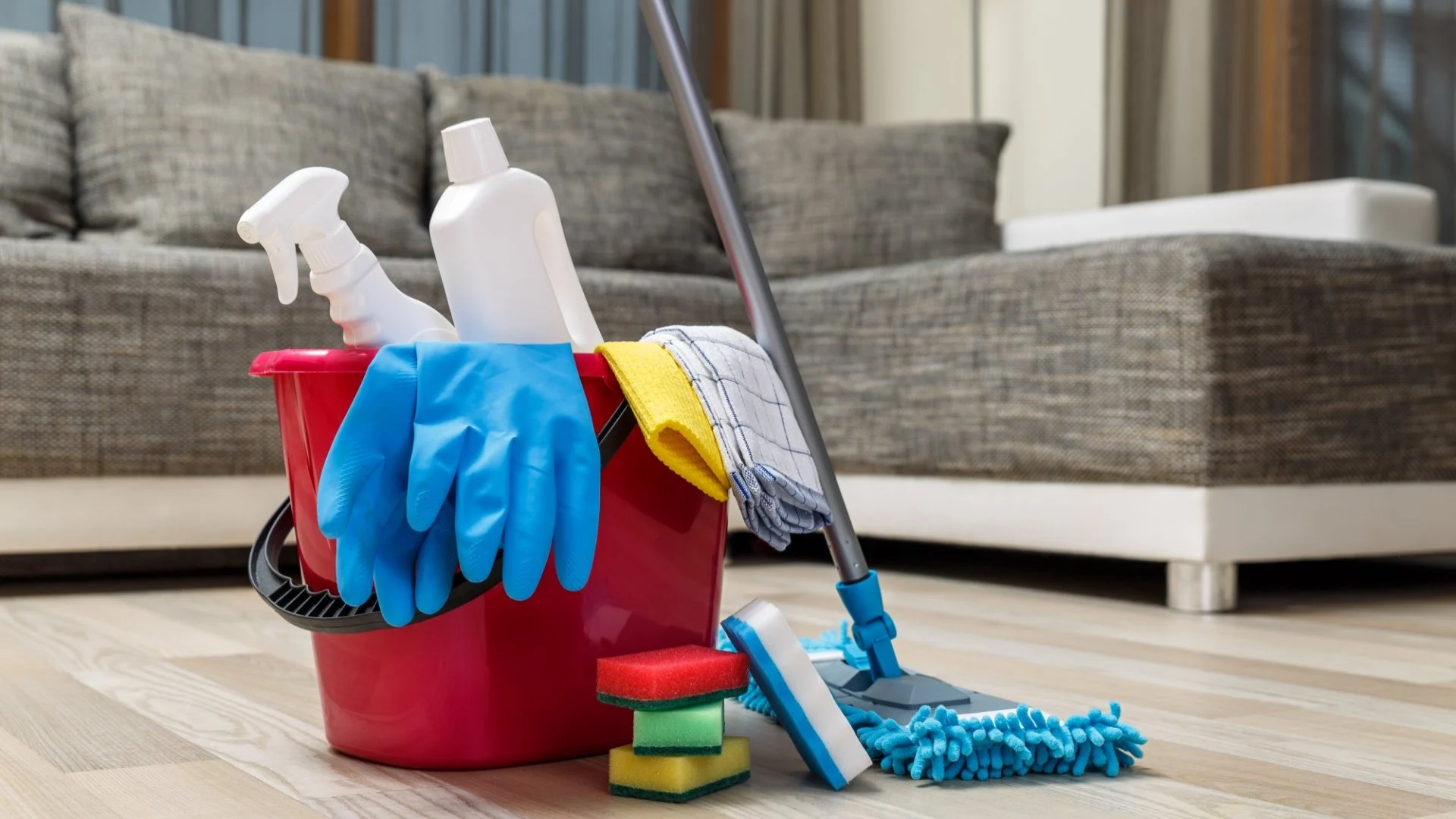 Cleaning supplies beside a living-room sofa