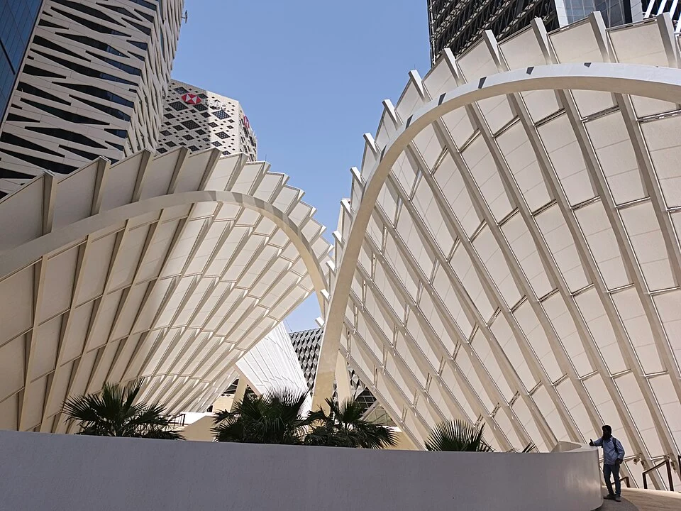 Curved canopy structures and blue sky at King Abdullah Financial District