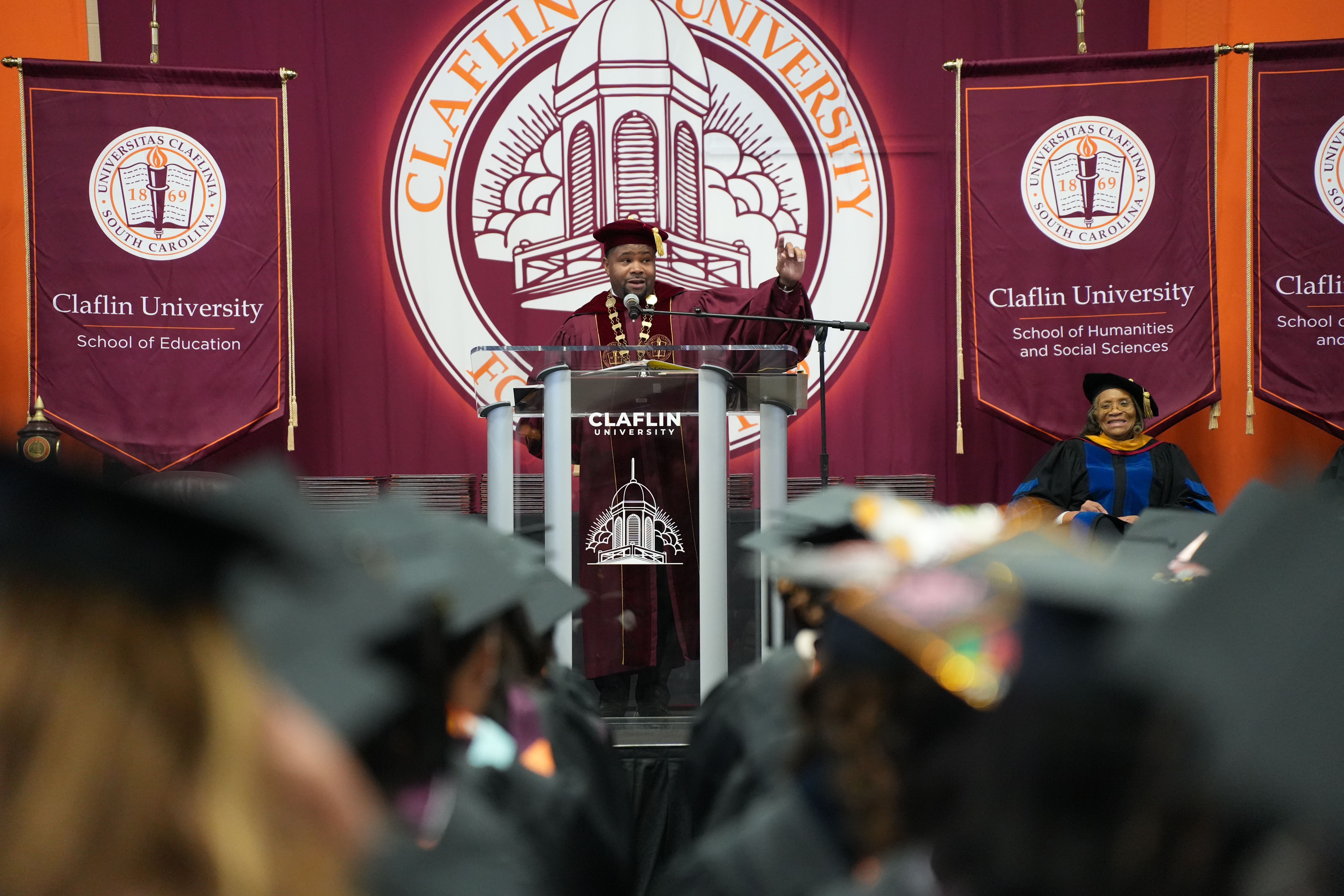 A Claflin leader speaking at the podium during commencement