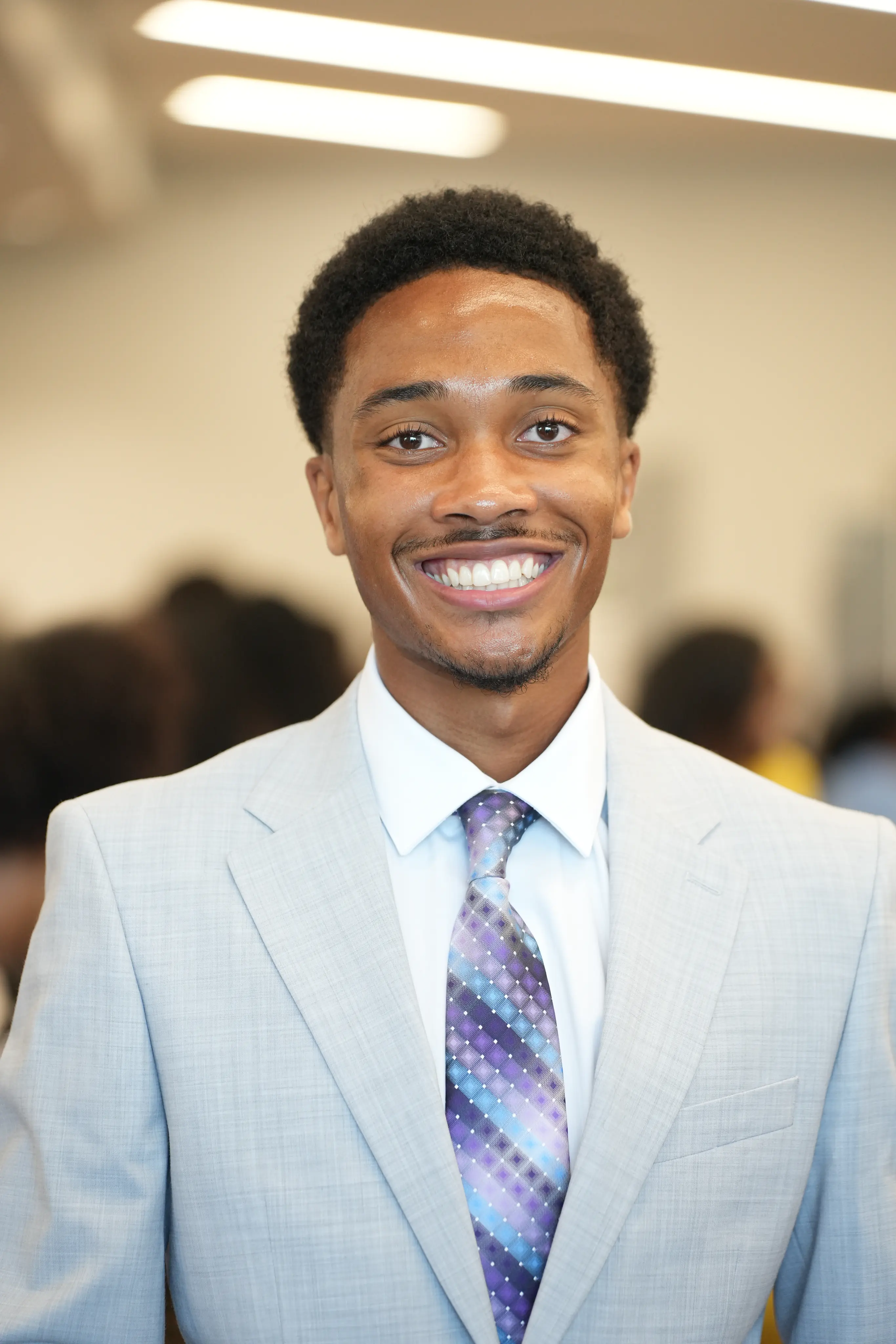 A smiling Claflin student dressed for a professional event