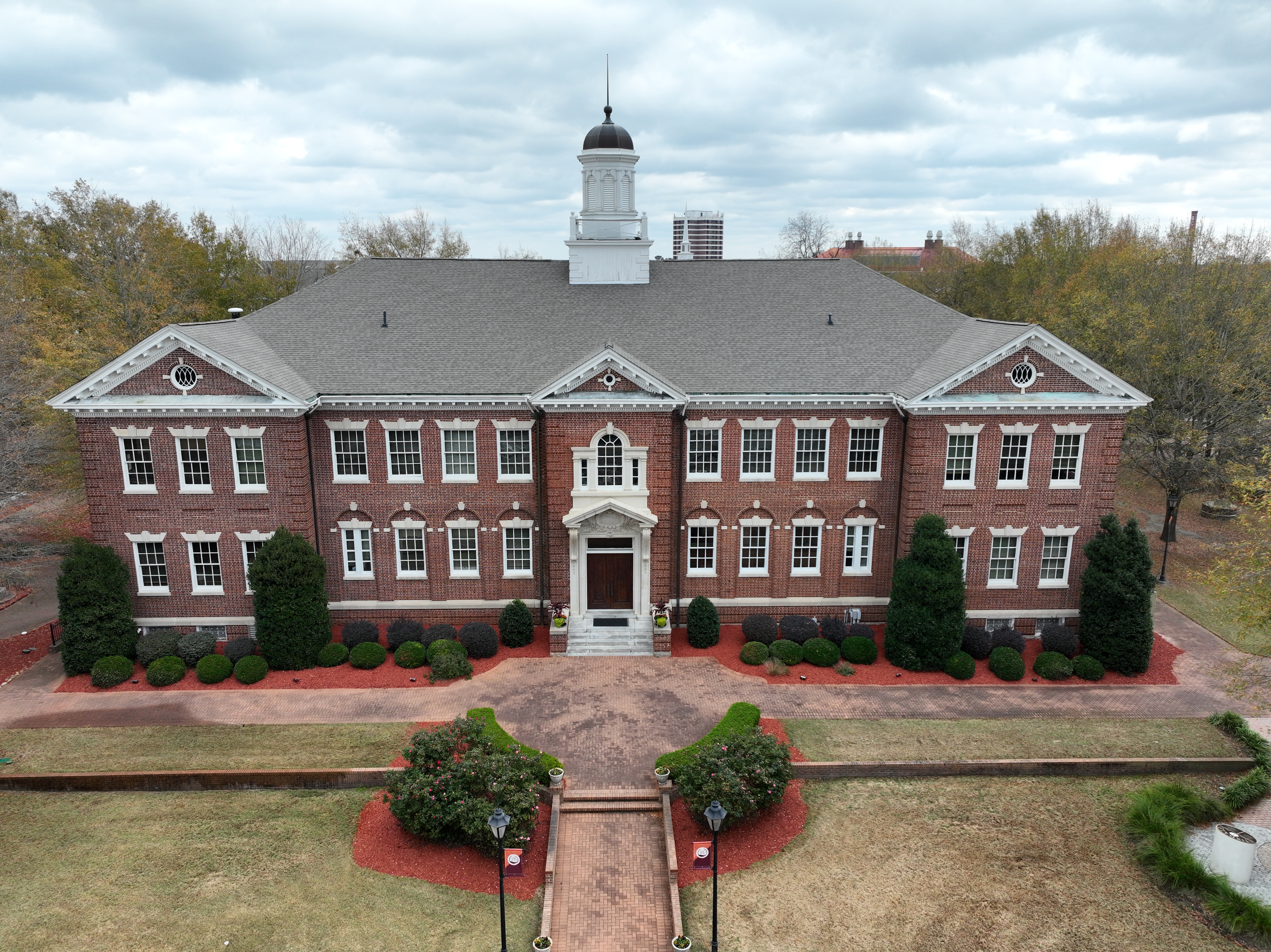 Aerial view of a red brick Claflin University building with a white cupola