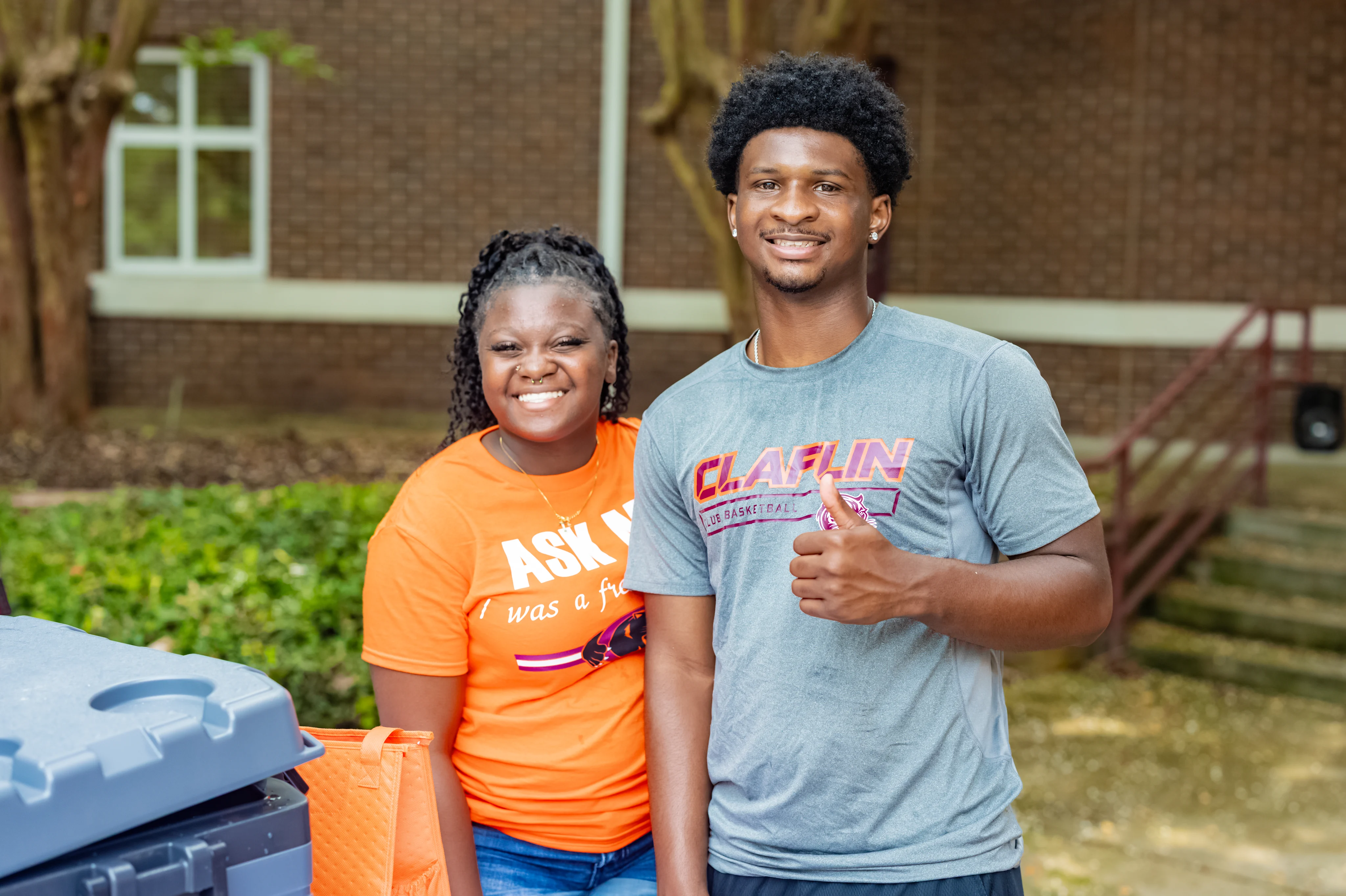 Two smiling Claflin students sharing a joyful moment on campus
