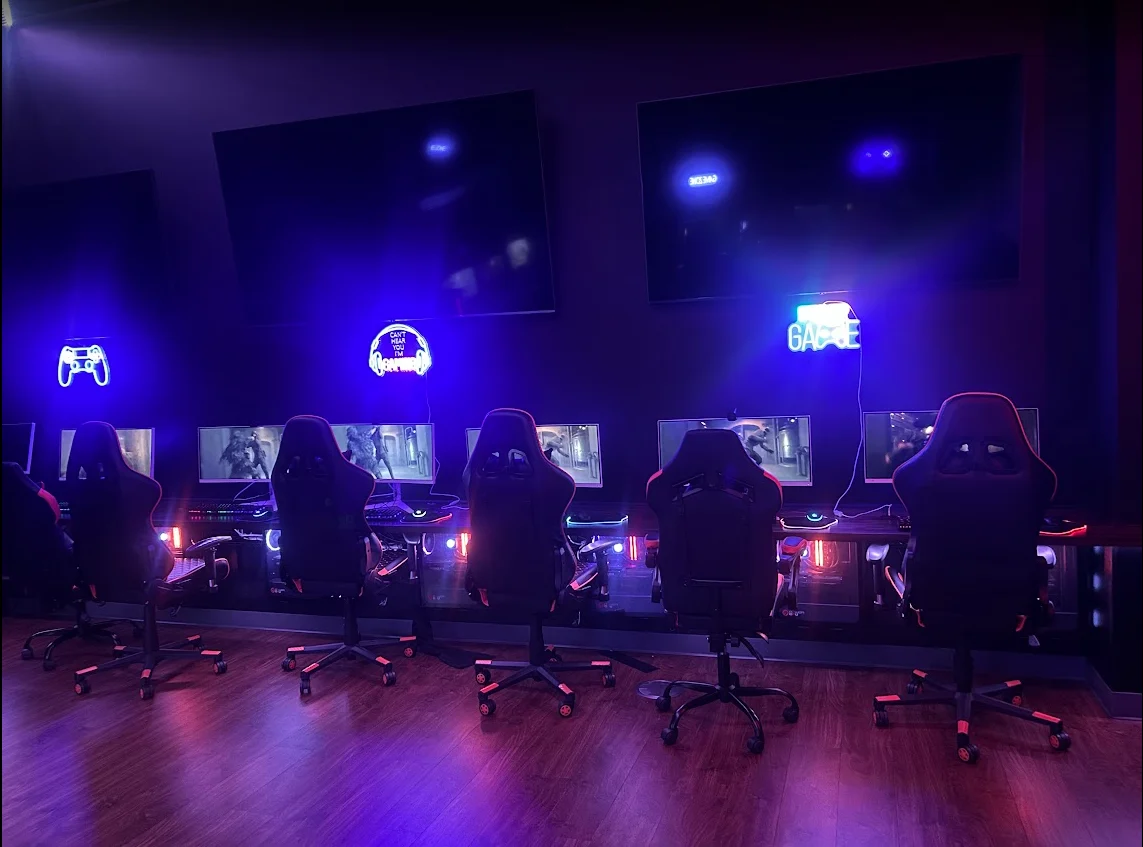 Center of the Claflin University Esports Lab with gaming stations and blue neon lighting