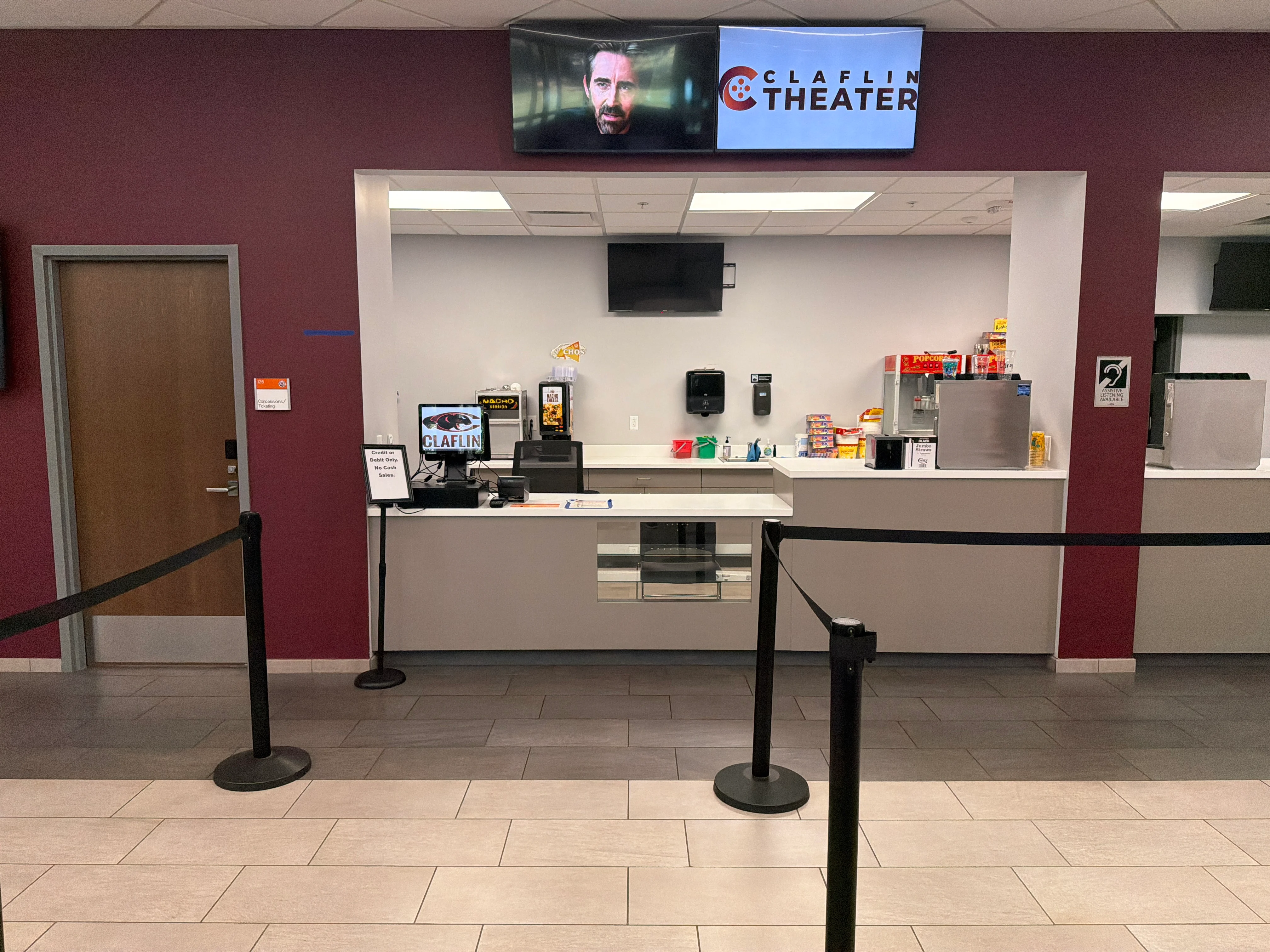 Claflin Theater concession stand with snack machines, digital displays, and the Claflin Theater logo